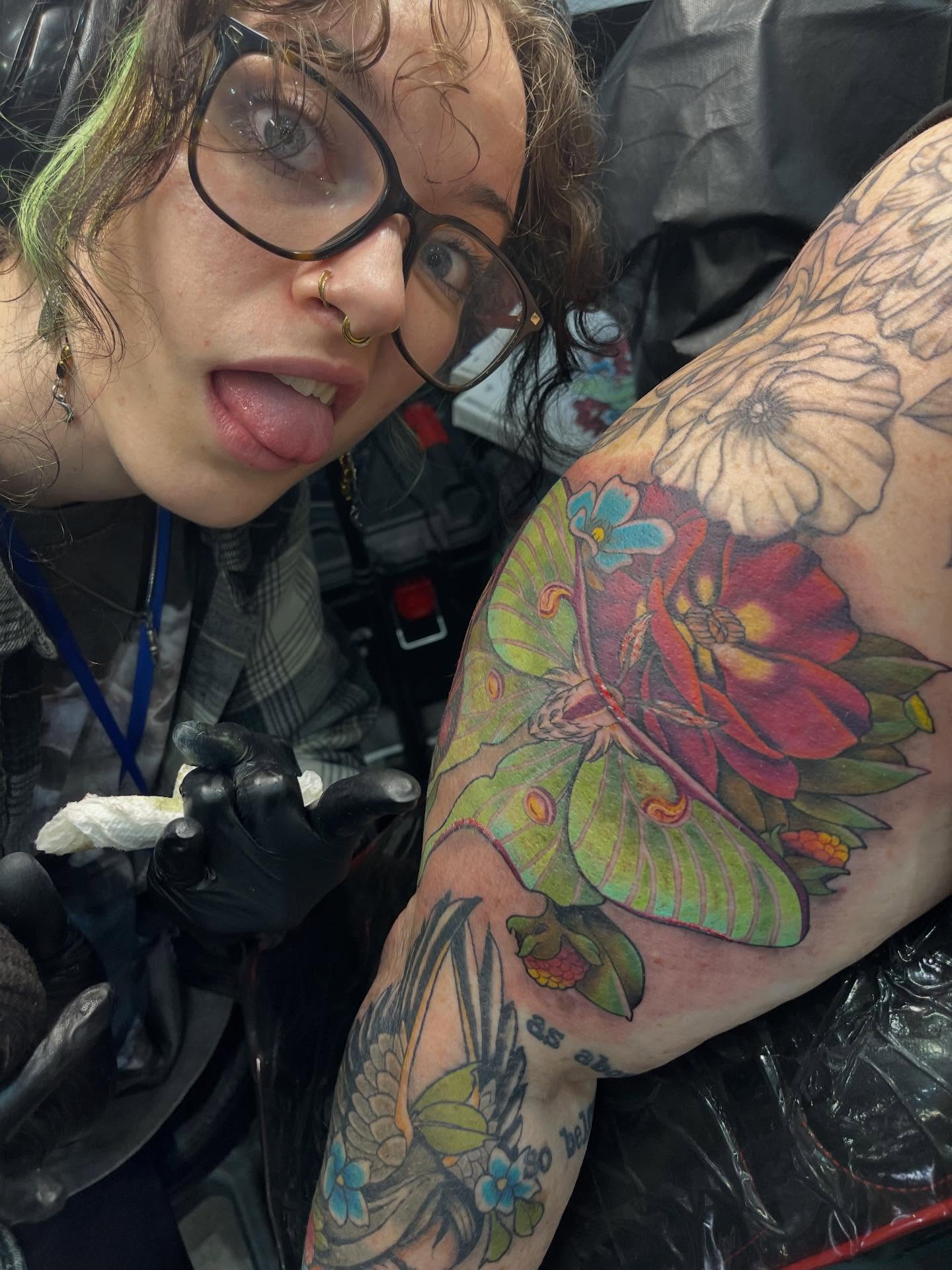 Butterfly and flowers new school tattoo on the upper arm by Penny - Tattooer
