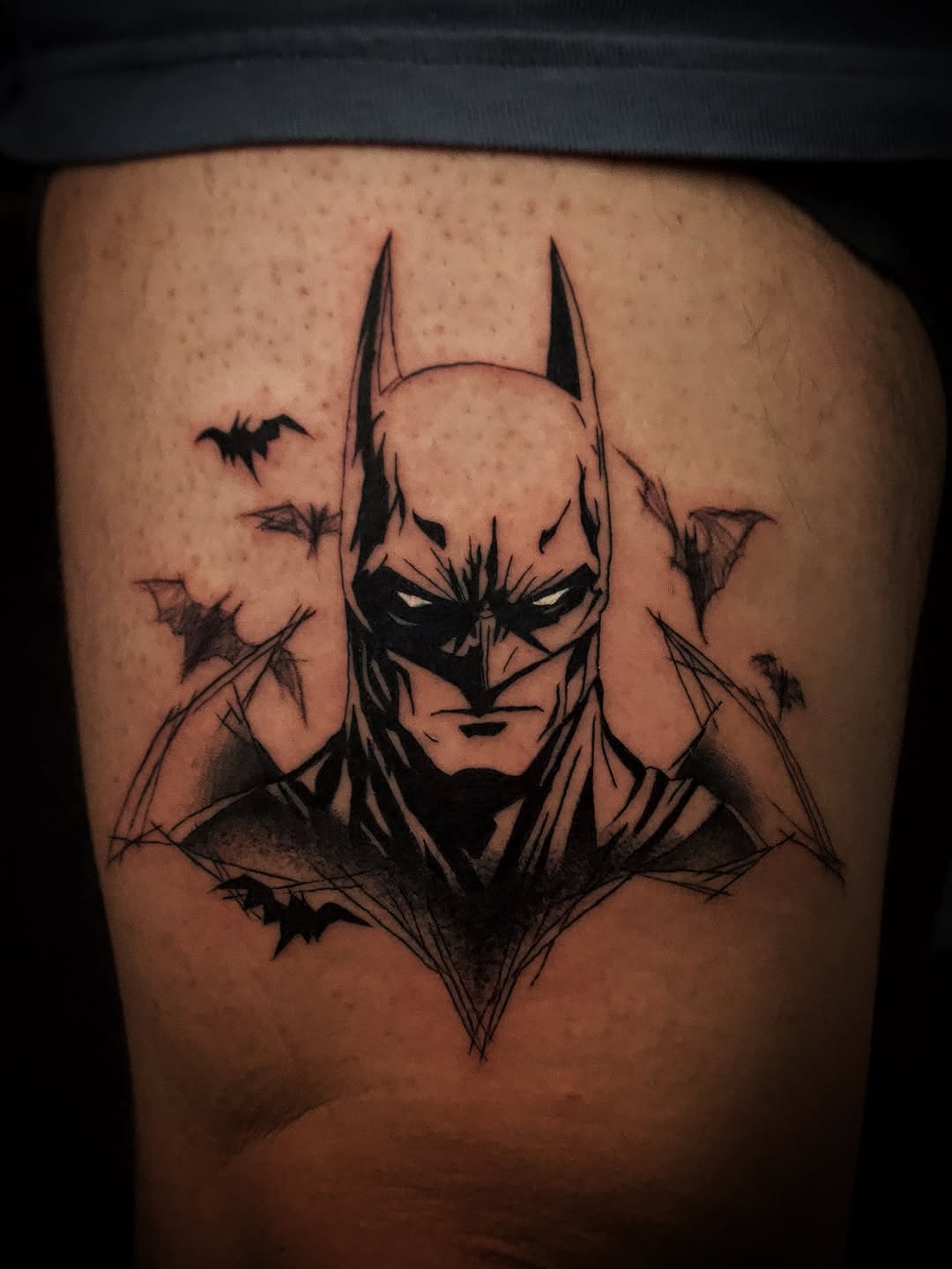 Batman portrait with bats realism tattoo on the thigh by Kanya, Alhambra, California