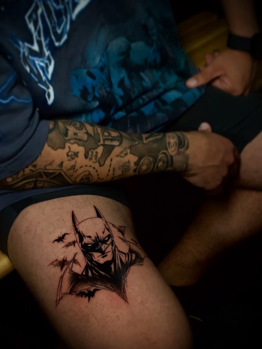 Batman portrait with bats realism tattoo on the thigh by Kanya, Alhambra, California