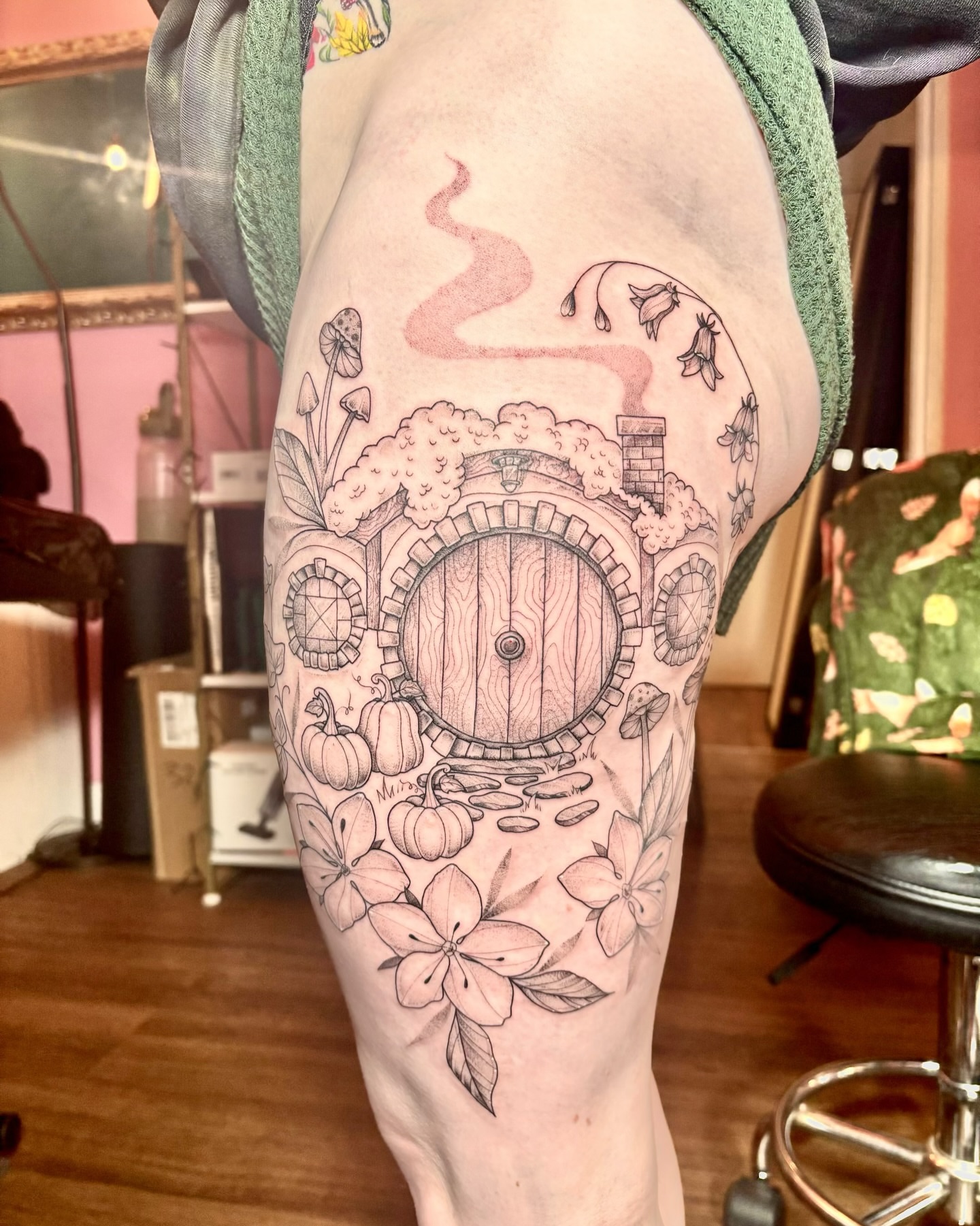Doorway with flowers black and grey tattoo on the thigh by Charlotte Brown, Leeds, England