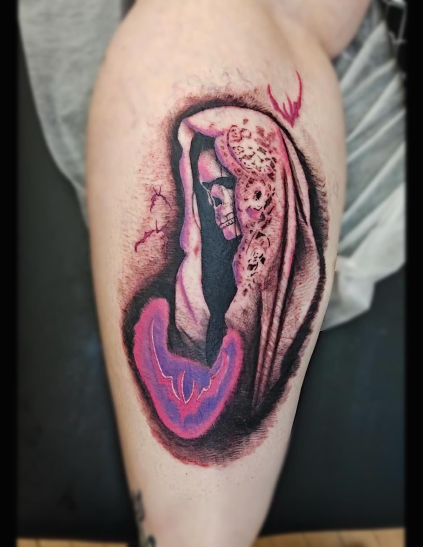 Skull and draped figure realism tattoo on the thigh by Sebastiana
