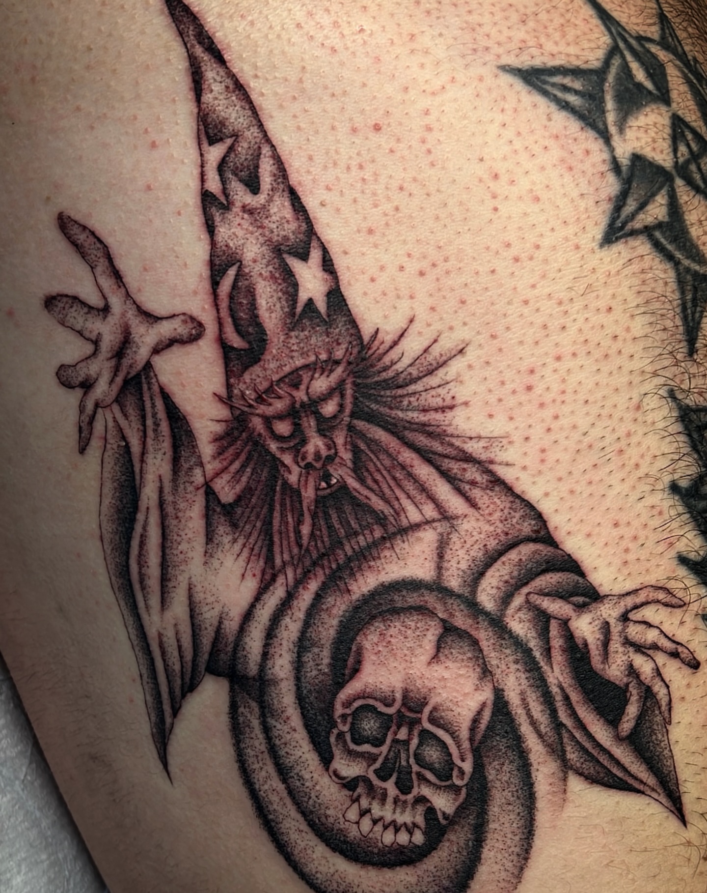 Demon with wizard hat dotwork tattoo on the thigh by David Delacruz
