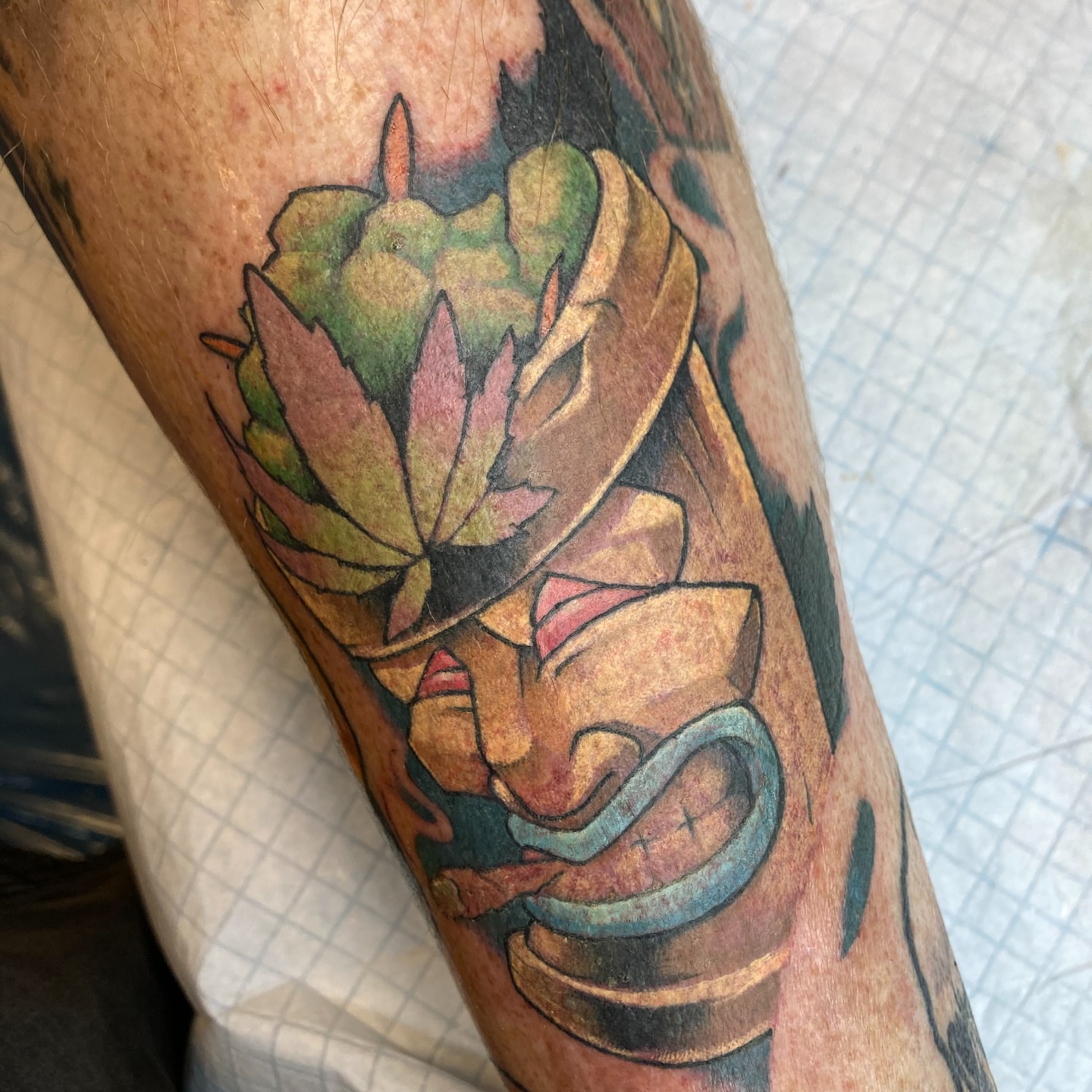 Mask with leaves realism tattoo on the forearm by Eathan Hale-(East TN) Newschool Tattoo Artist