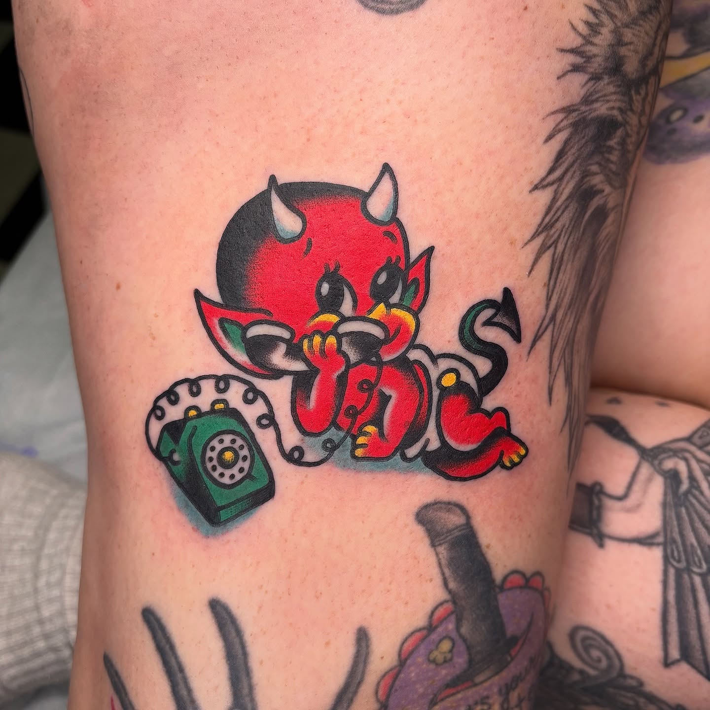 Red devil with phone American traditional tattoo on the forearm by Andrew Silva