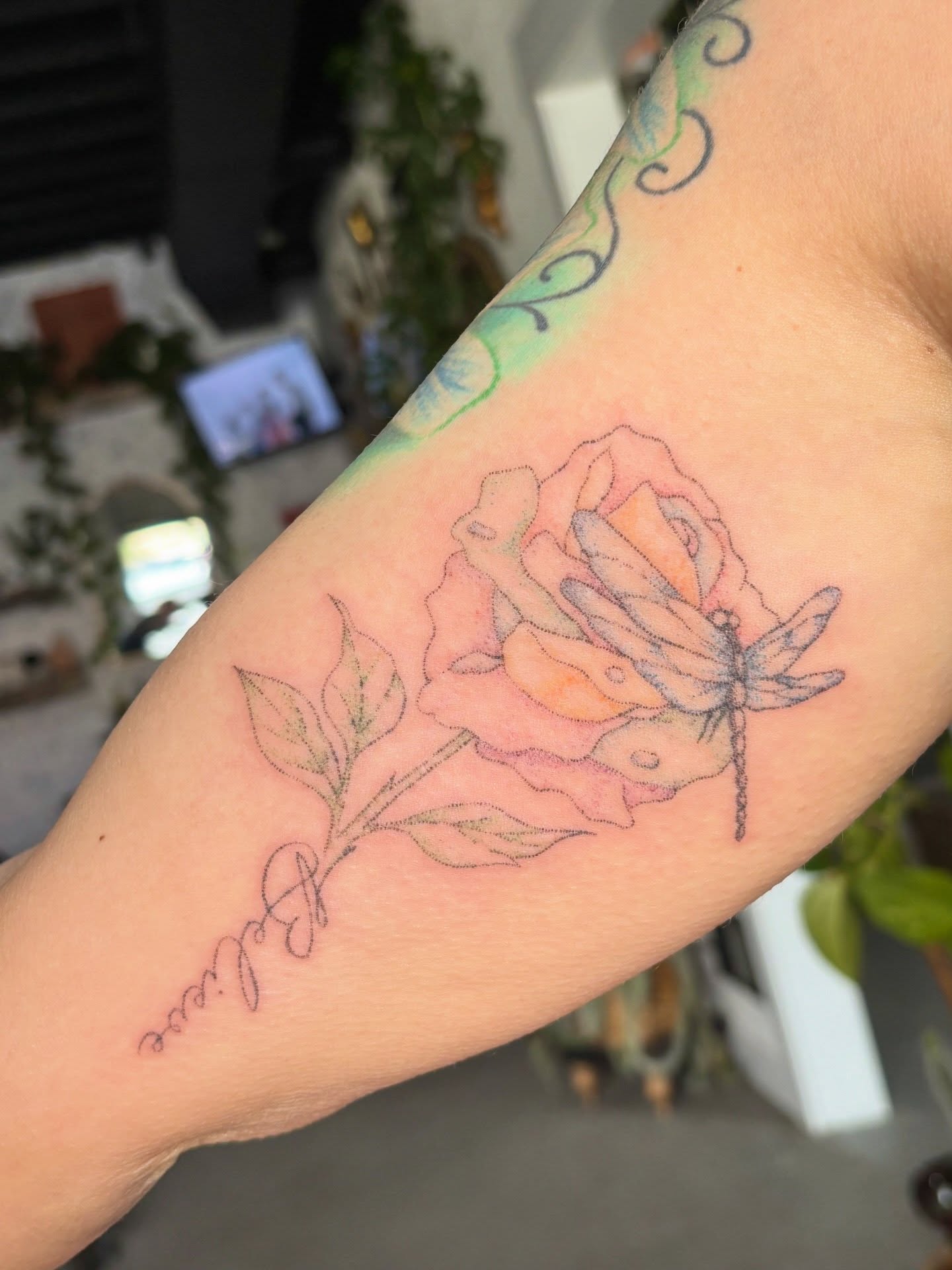 Rose and dragonfly realism tattoo on the forearm by Ashley, Elk Horn, Iowa
