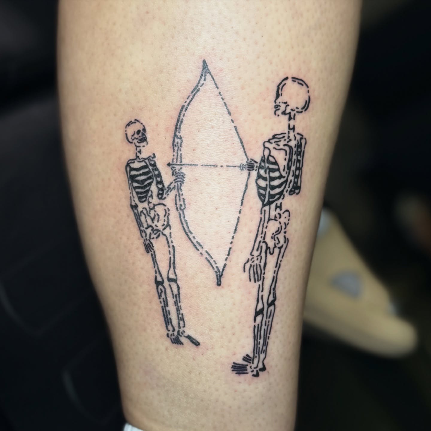 Skeletons with bow and arrow black and grey tattoo on the forearm by 🌸Blossom🌸
