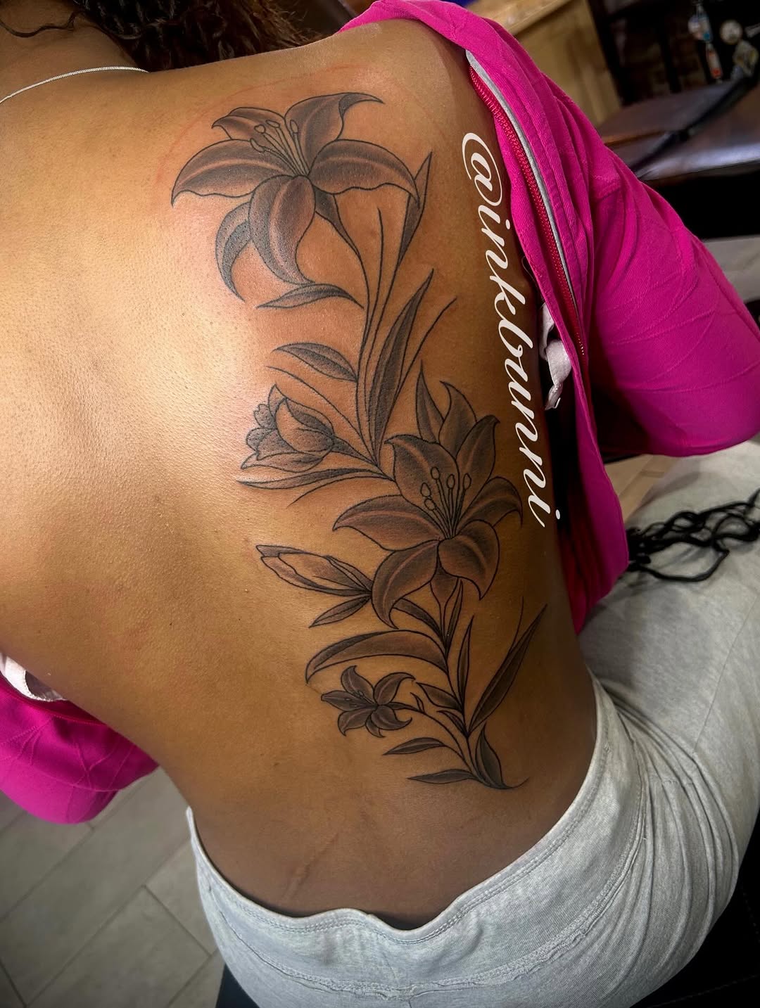Lily flowers fine line tattoo on the back by Hailey Aka inkbunni, Detroit, Michigan