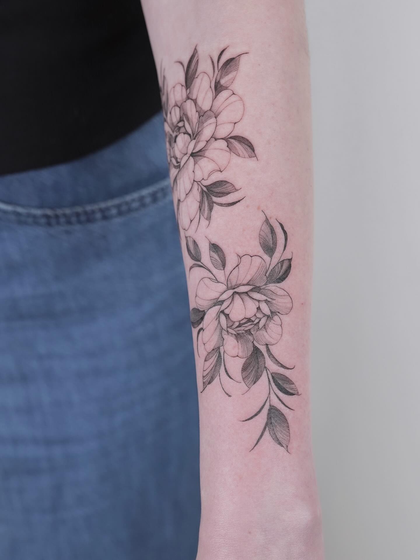 Peonies and leaves fine line tattoo on the forearm by Julia
