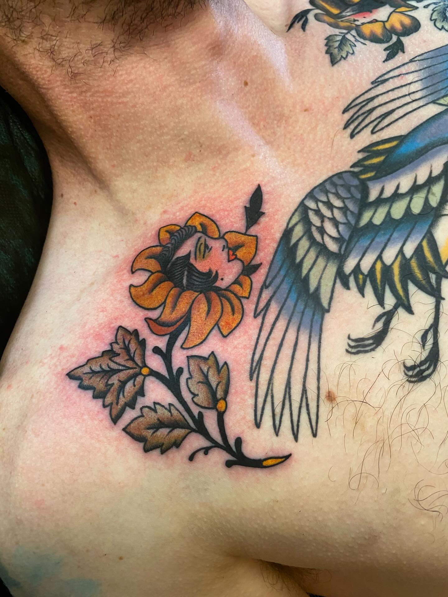 Flower with human face American traditional tattoo on the chest by Jaclin Grace Hastings