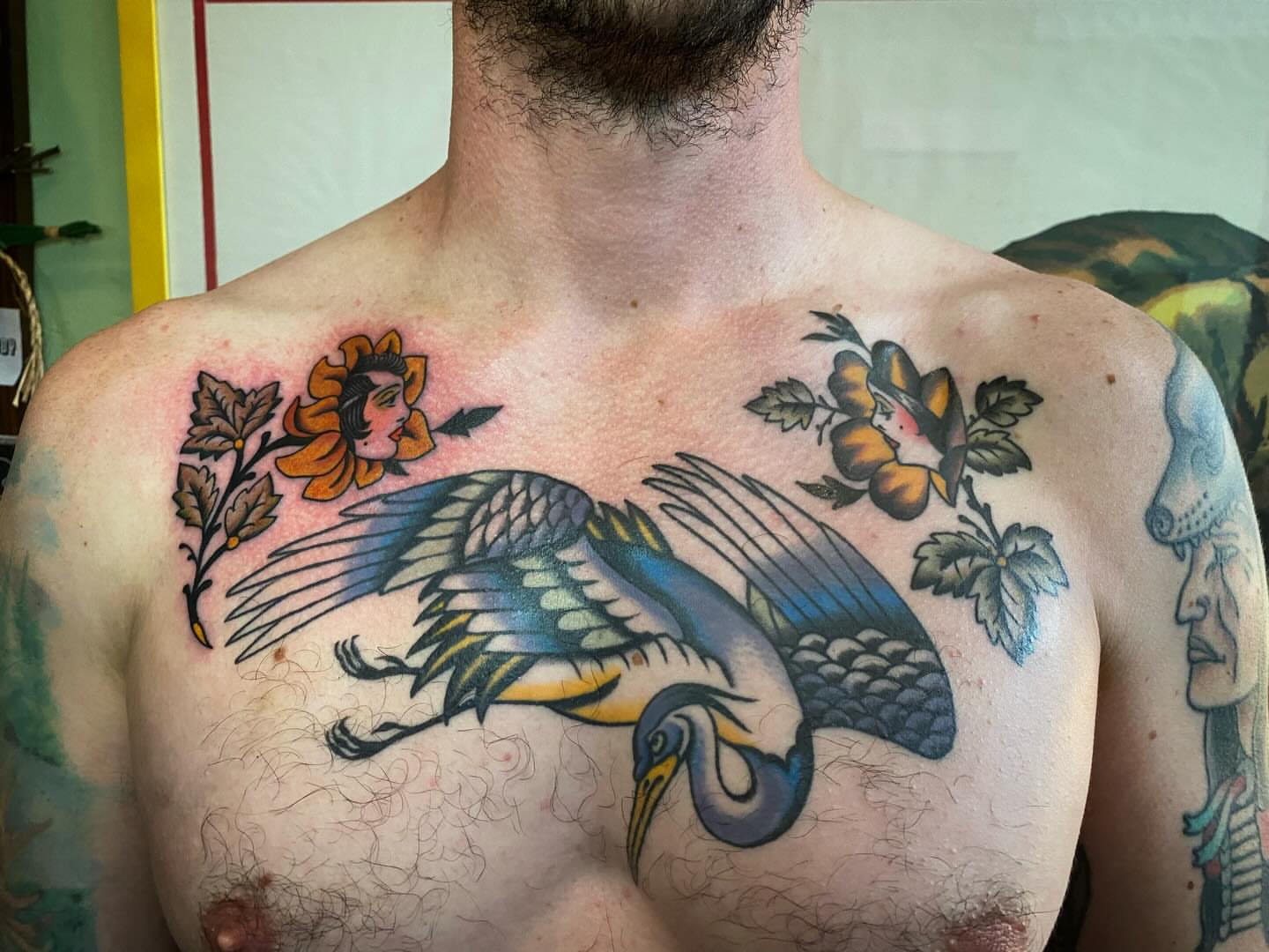 Heron and floral American traditional tattoo on the chest by Jaclin Grace Hastings