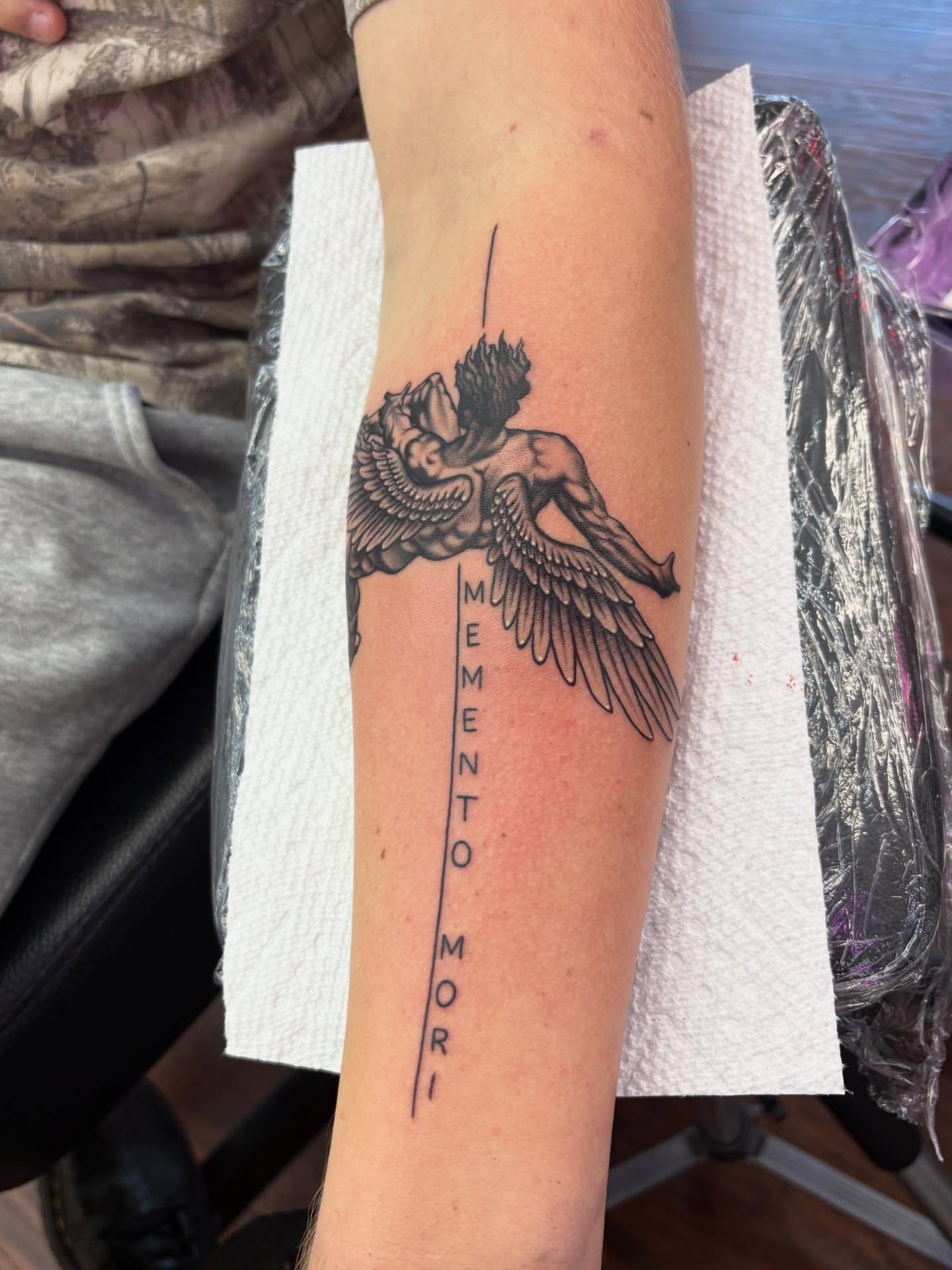 Angel and skull realism tattoo on the forearm by Skye California