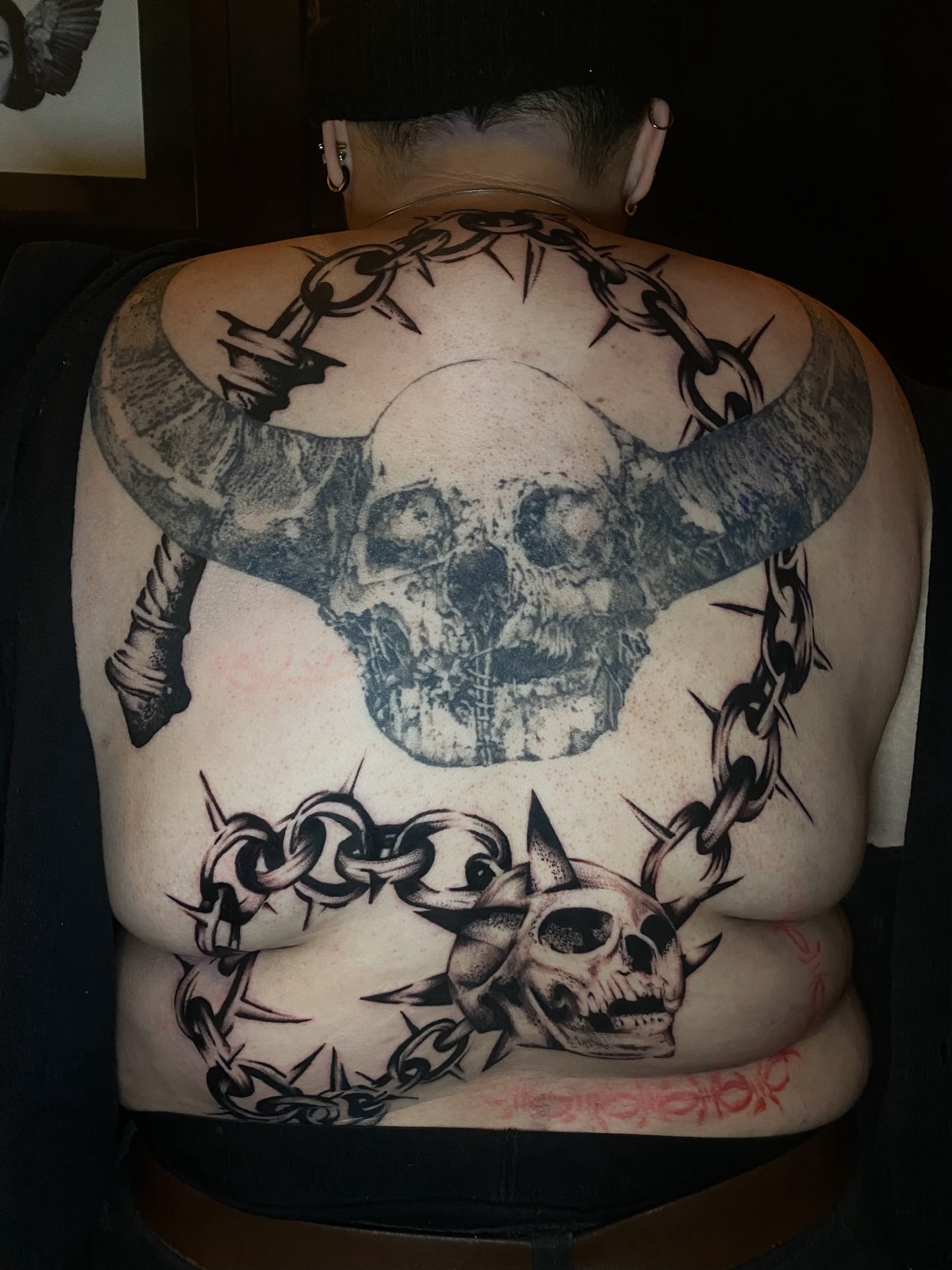 Skulls and chains dotwork tattoo on the back by Cherry Jane 🍒