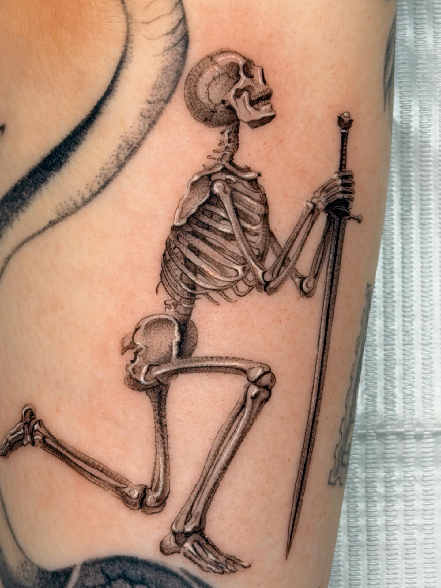 Skeleton with sword black and grey tattoo on the forearm by Nate Weaver
