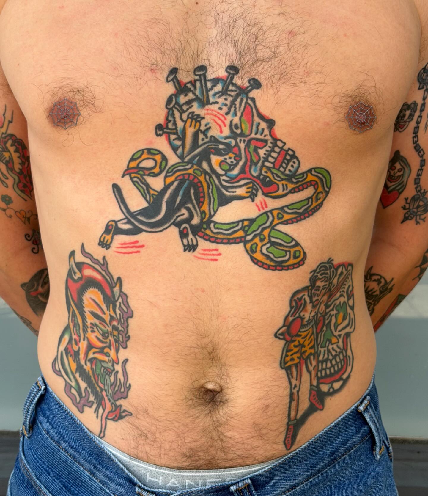 Skull and snake American traditional tattoo on the chest by Jake