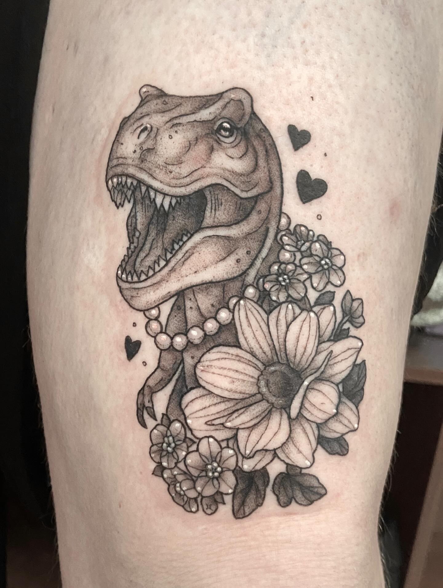 Dinosaur with flowers dotwork tattoo on the thigh by Dawn Carr, Richmond, Virginia