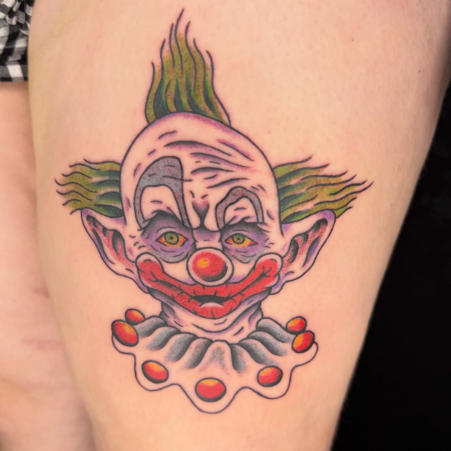 Clown American traditional tattoo on the thigh by Kaysen