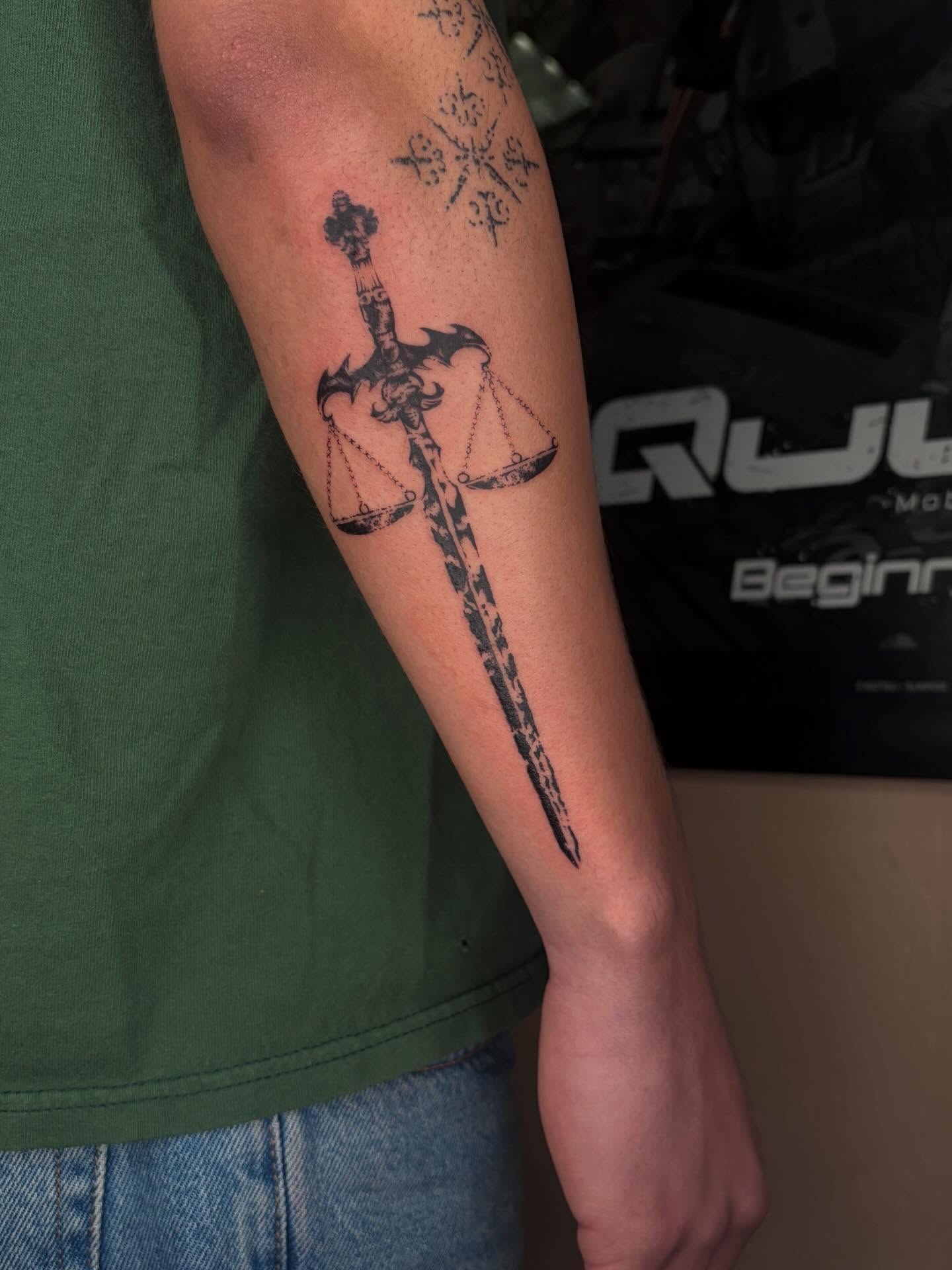 Sword and scales black and grey tattoo on the forearm by ☆ gia