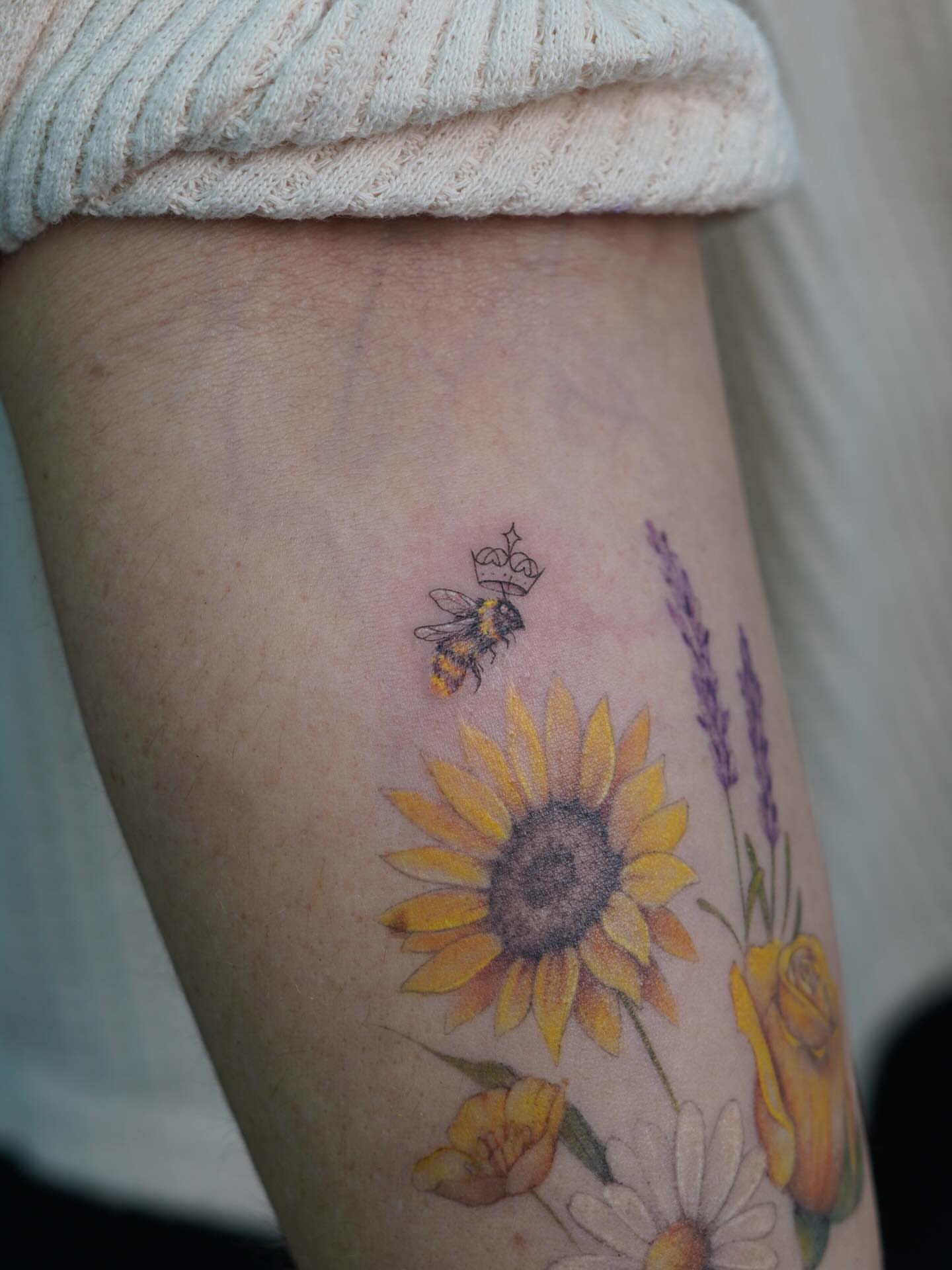 Sunflower and bee realism tattoo on the forearm by Danae Andino