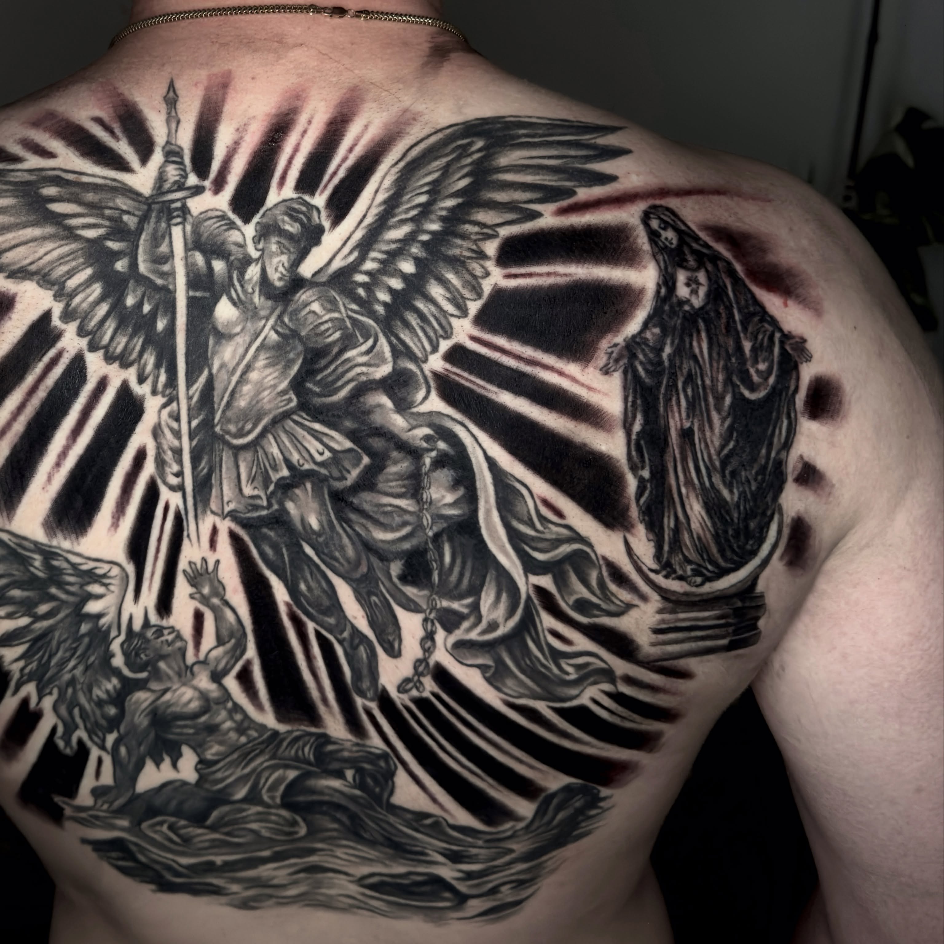 Religious battle scene realism tattoo on the back by Butz Tattoos