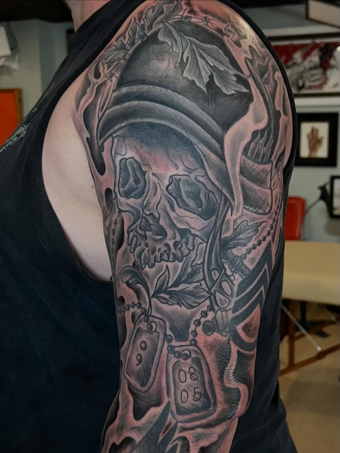 Skull and dog tags realism tattoo on the upper arm by Jessica Kloos