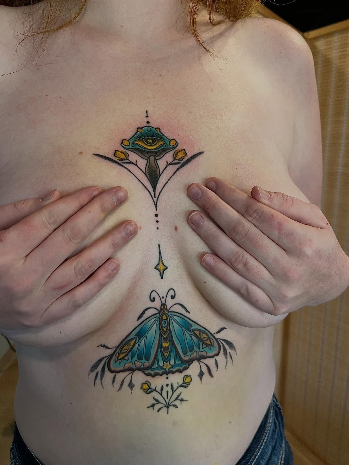 Butterfly and floral design geometric tattoo on the chest by Jessica Kloos
