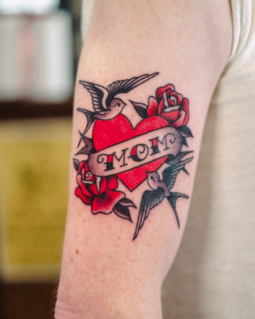 Heart with 'mom' banner American traditional tattoo on the forearm by Dan Gilsdorf, Portland, Oregon