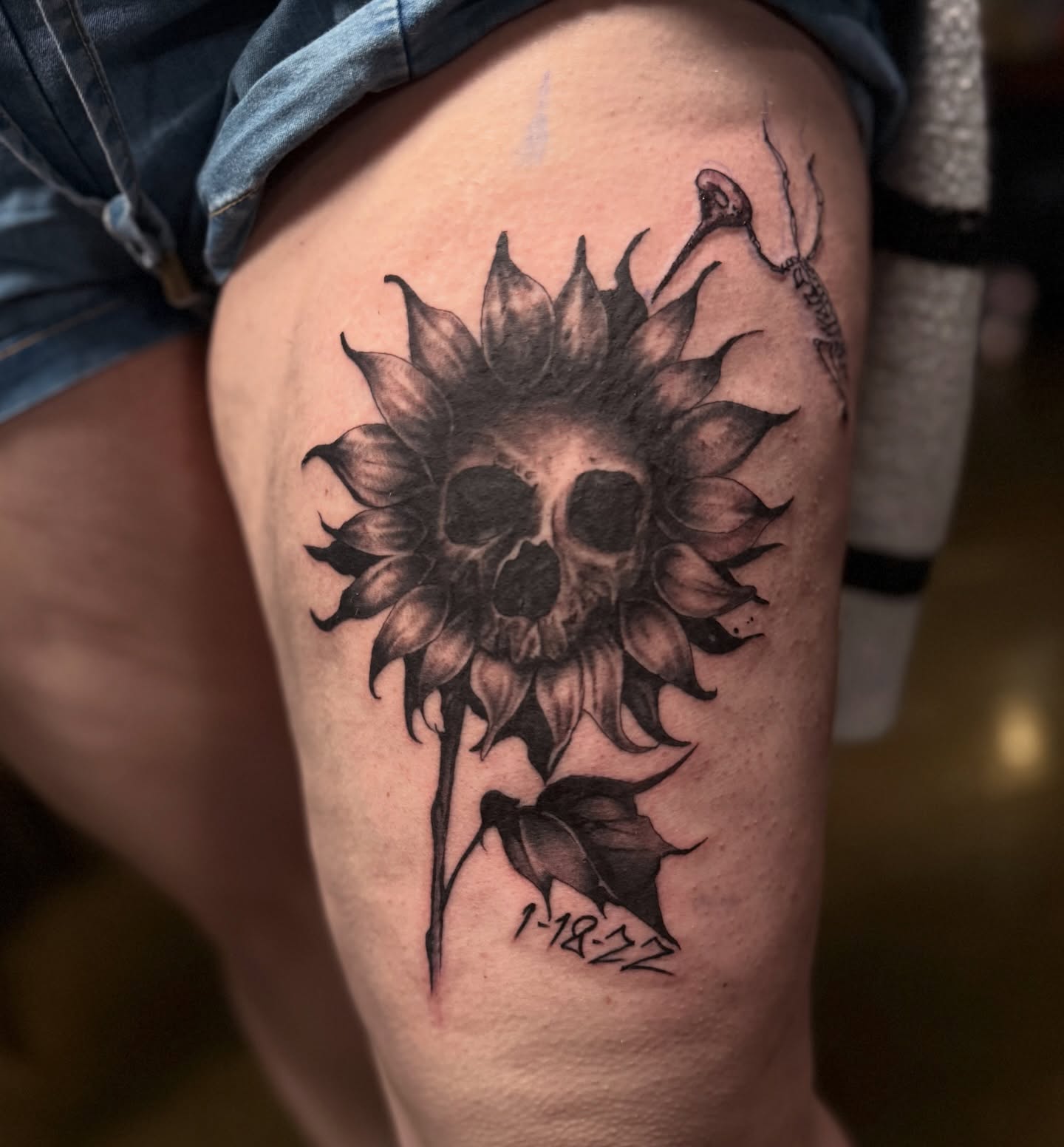 Sunflower skull realism tattoo on the thigh by Miles Haysmith