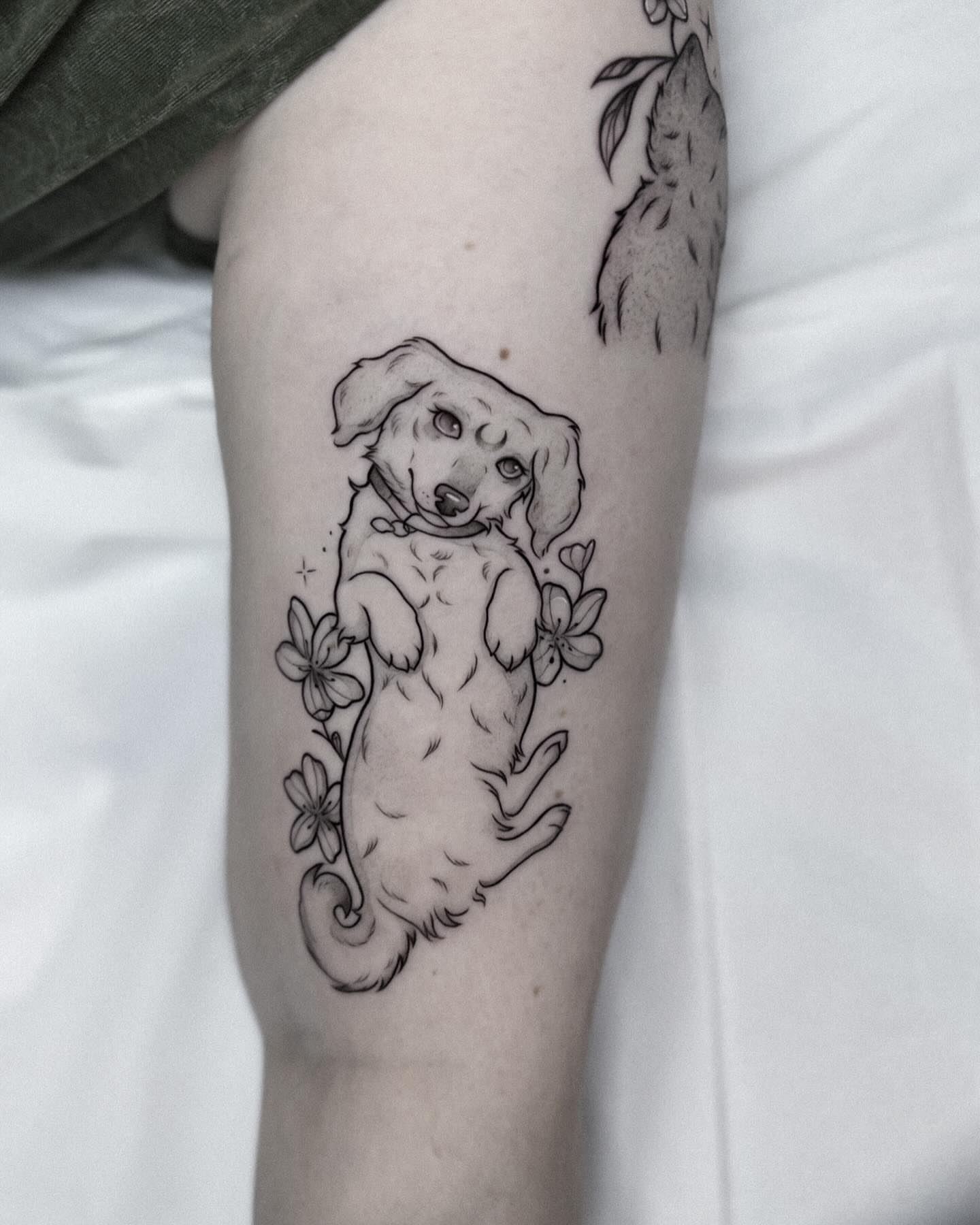 Dachshund puppy realism tattoo on the forearm by Whimsical Tattoos