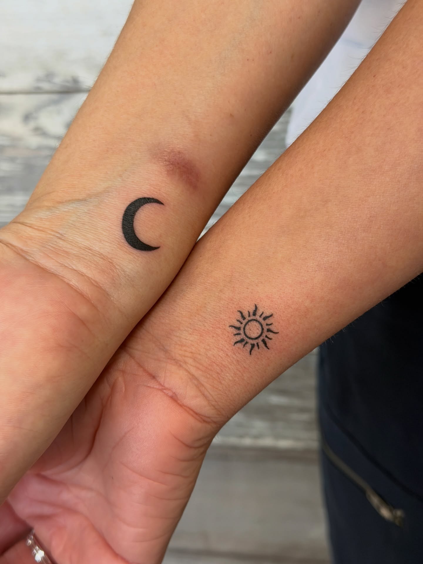 Sun and moon minimalist tattoo on the forearm by Raciel Fabian Romero