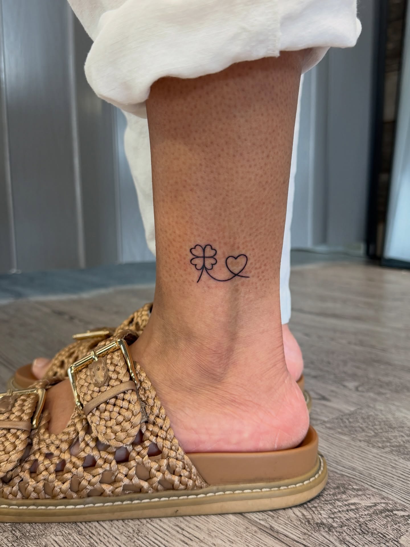 Clover and heart fine line tattoo on the foot by Raciel Fabian Romero