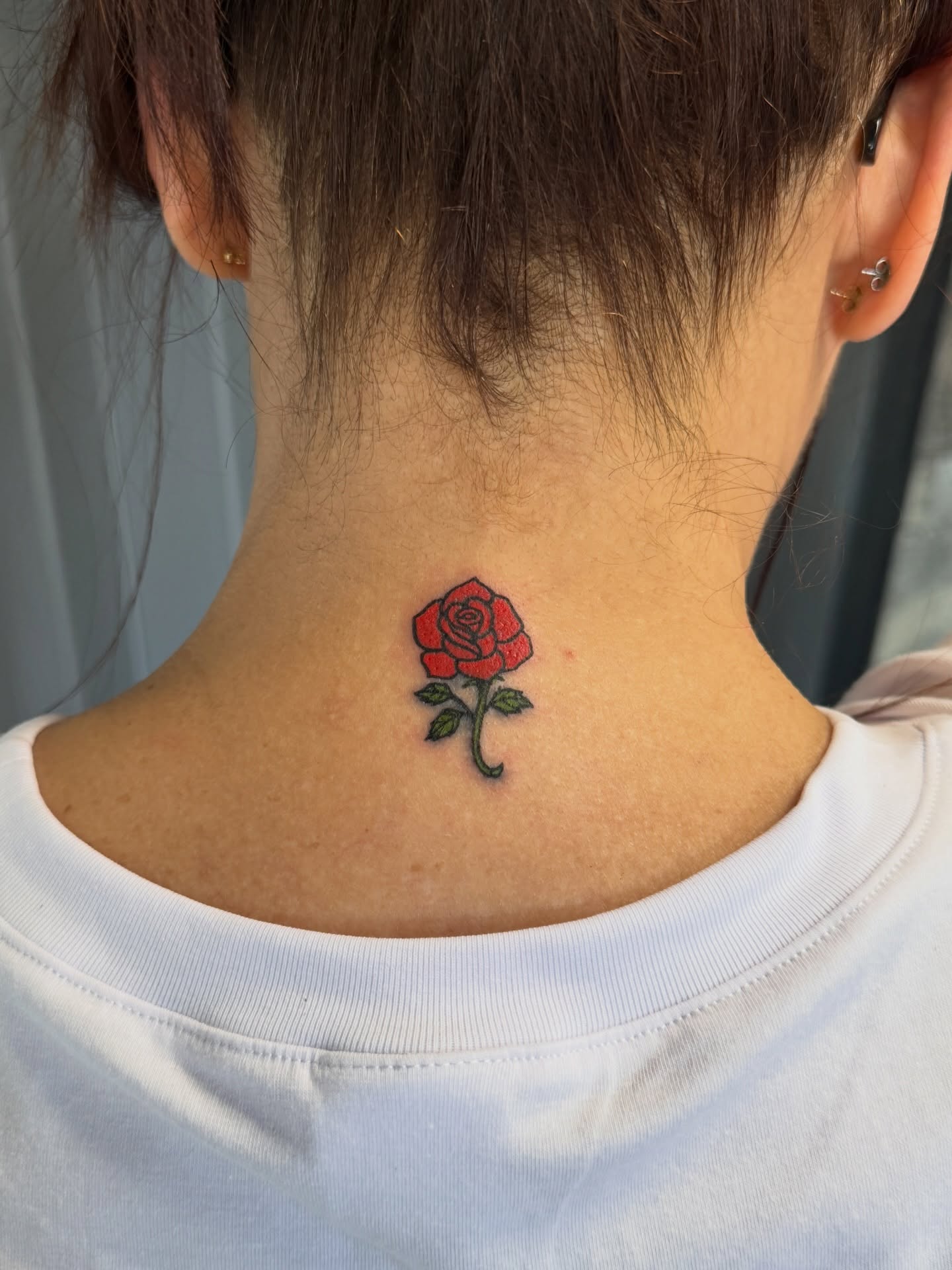 Red rose realism tattoo on the neck by Raciel Fabian Romero
