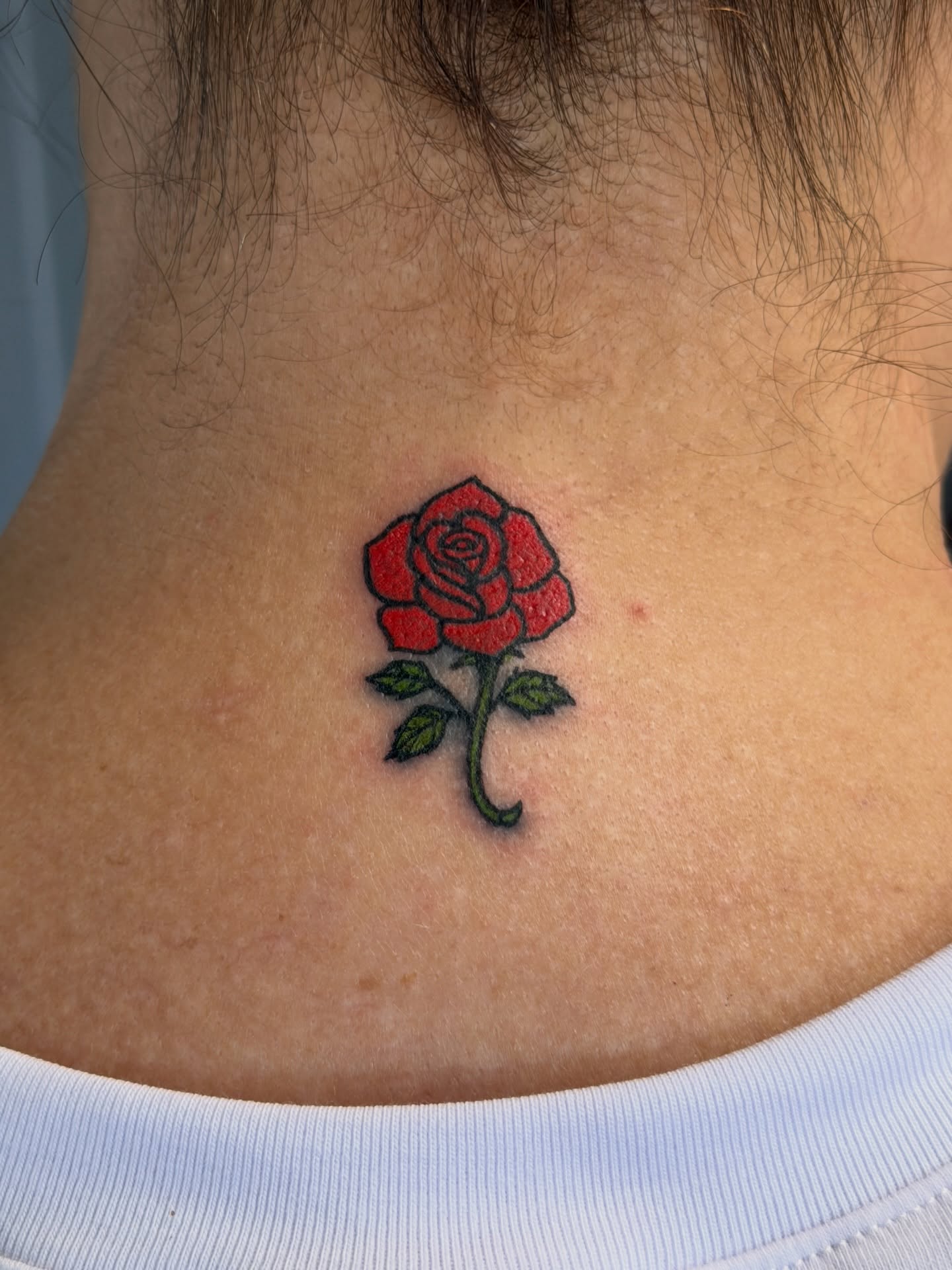 Red rose American traditional tattoo on the neck by Raciel Fabian Romero