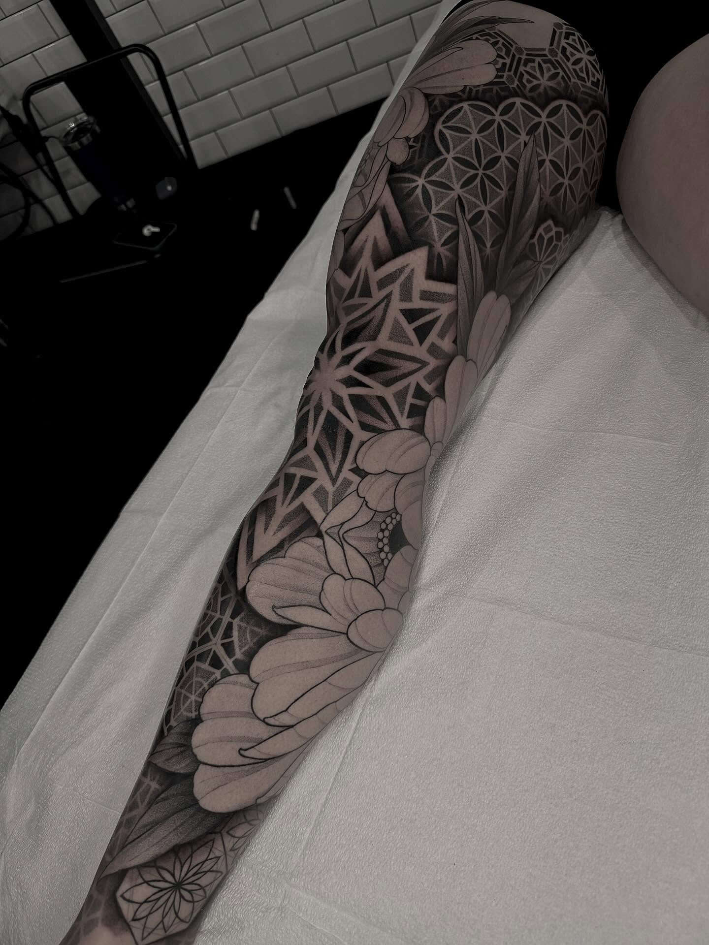 Geometric floral pattern geometric tattoo on the forearm by Kevin Johnson