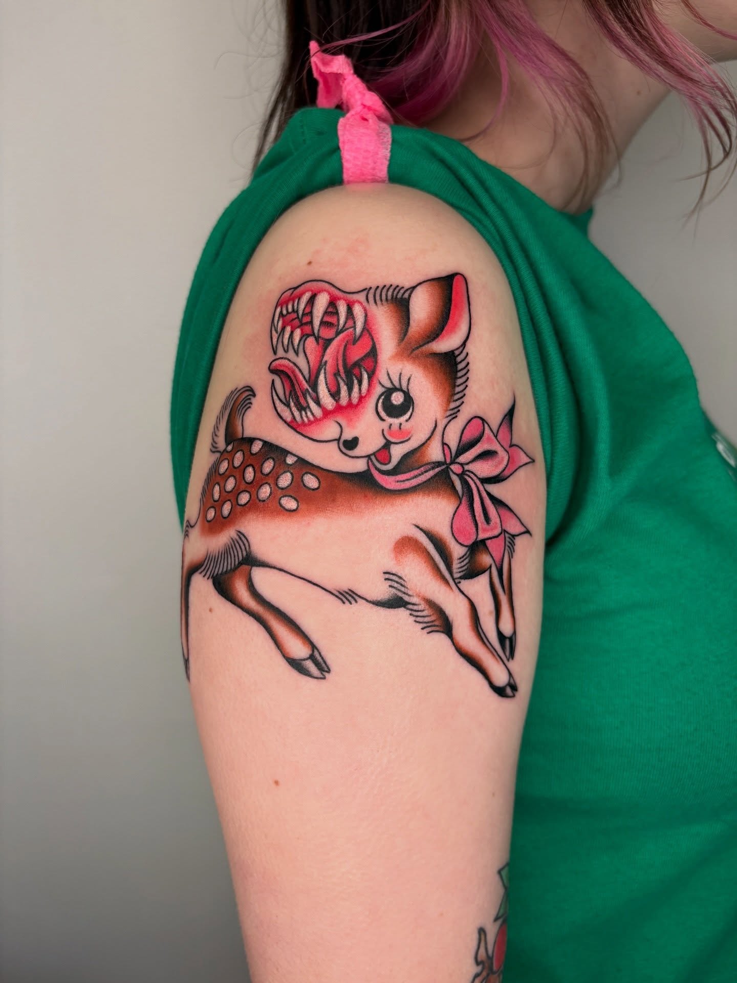 Deer with bow new school tattoo on the shoulder by Nori