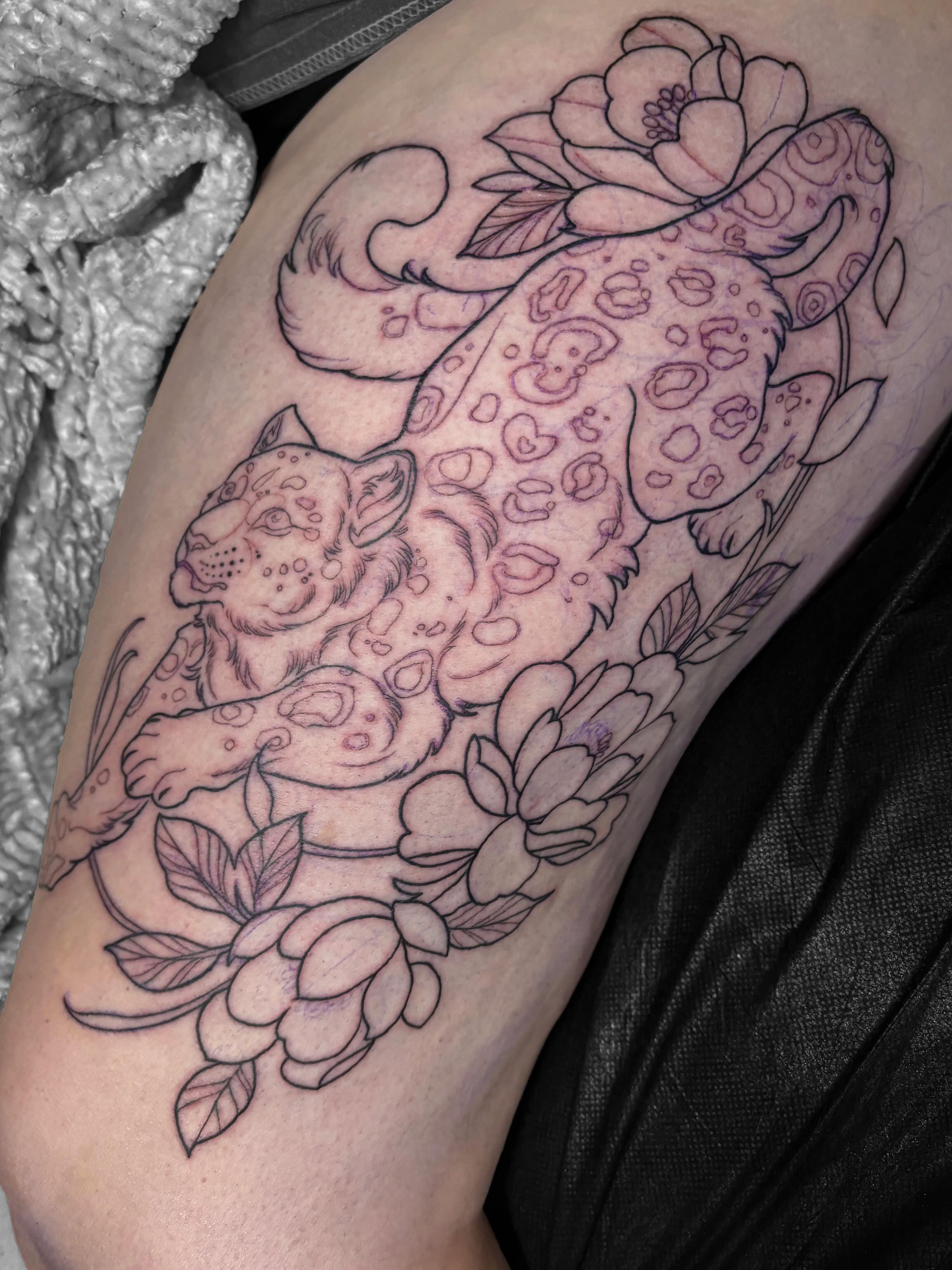 Snow leopard and flowers black and grey tattoo on the thigh by Alex