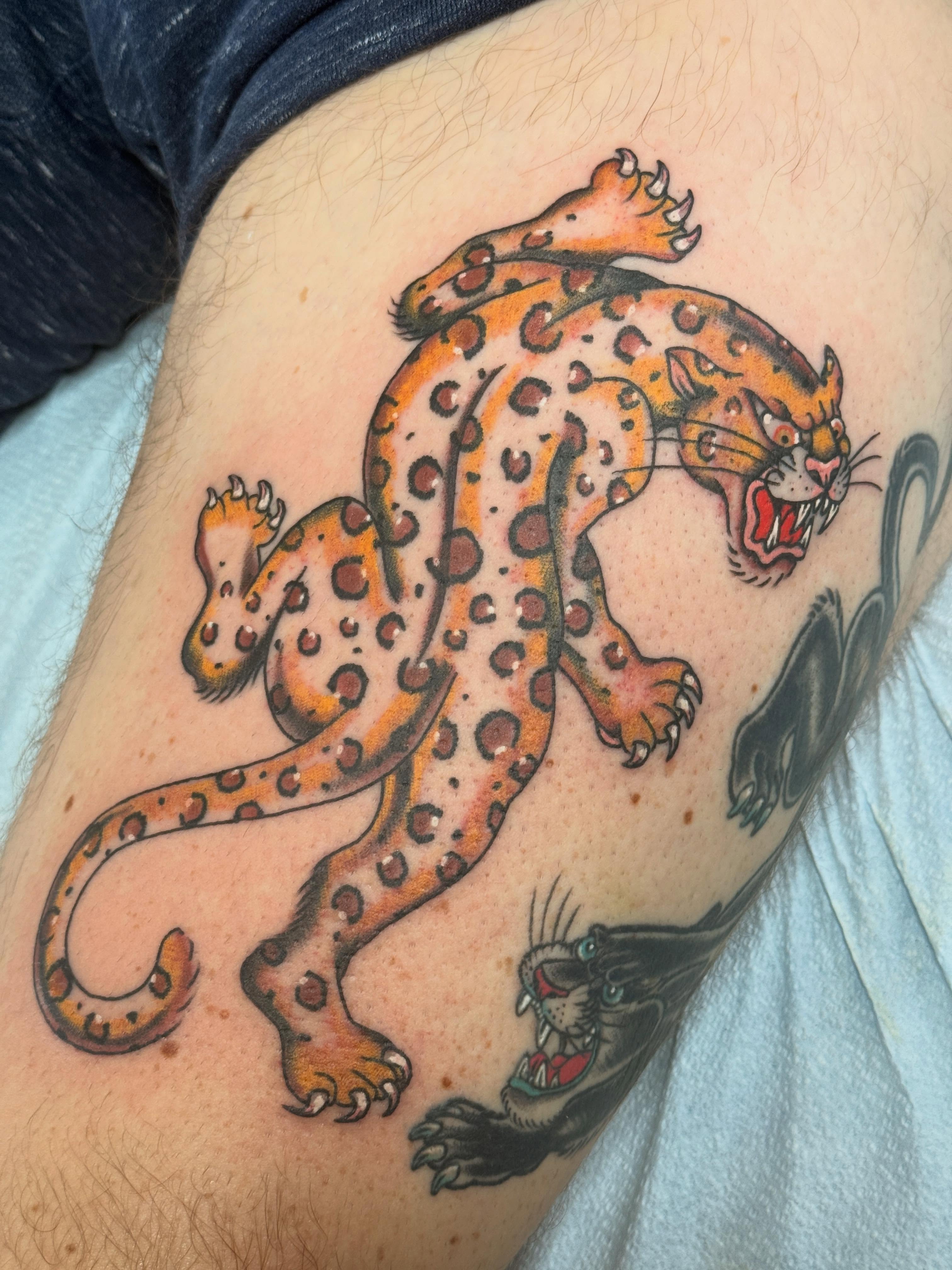 Leopard American traditional tattoo on the thigh by Megan Sue Causemaker