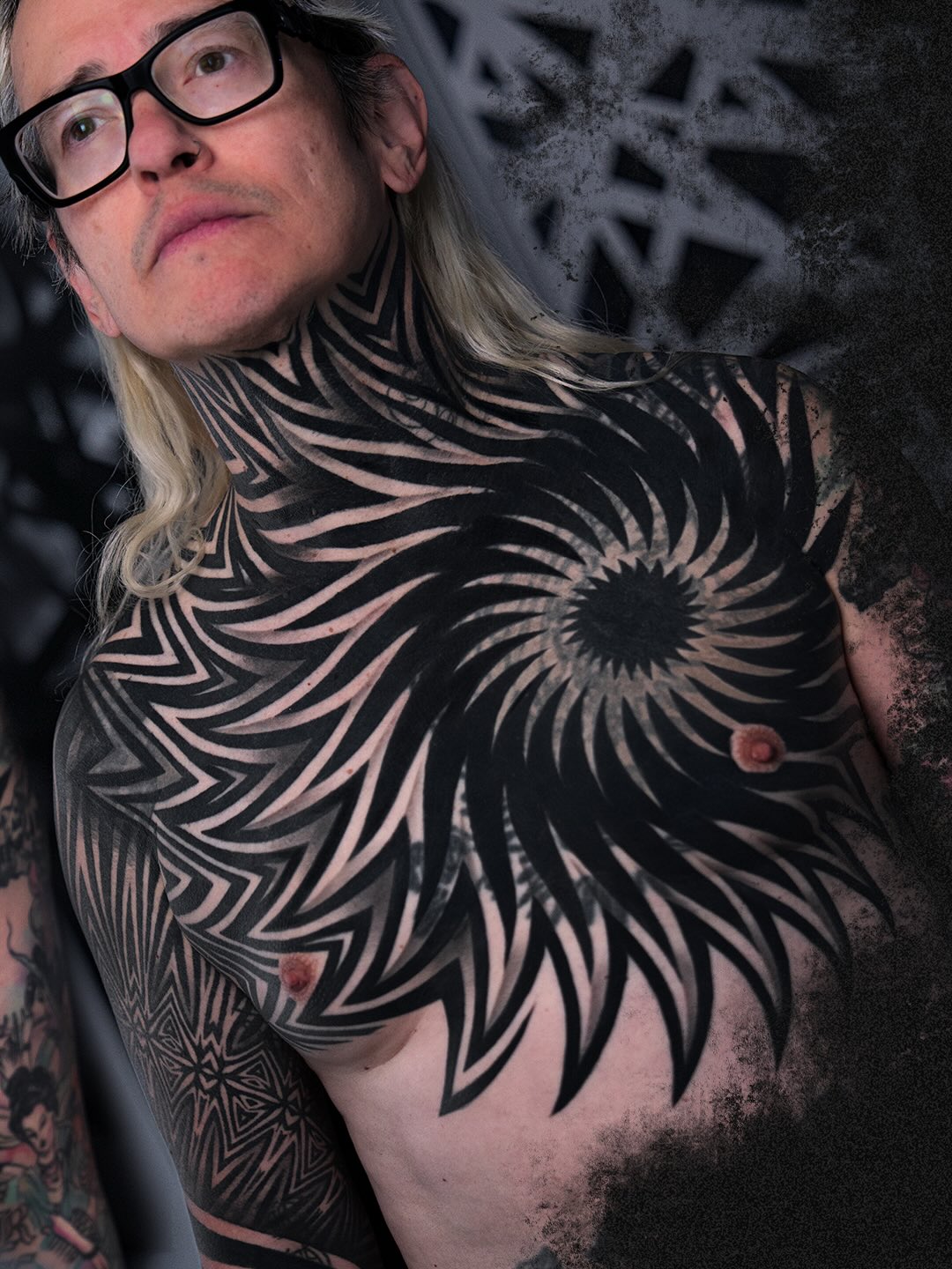 Geometric spiral and patterns tribal tattoo on the chest by Ilya Cascad Kandaurov