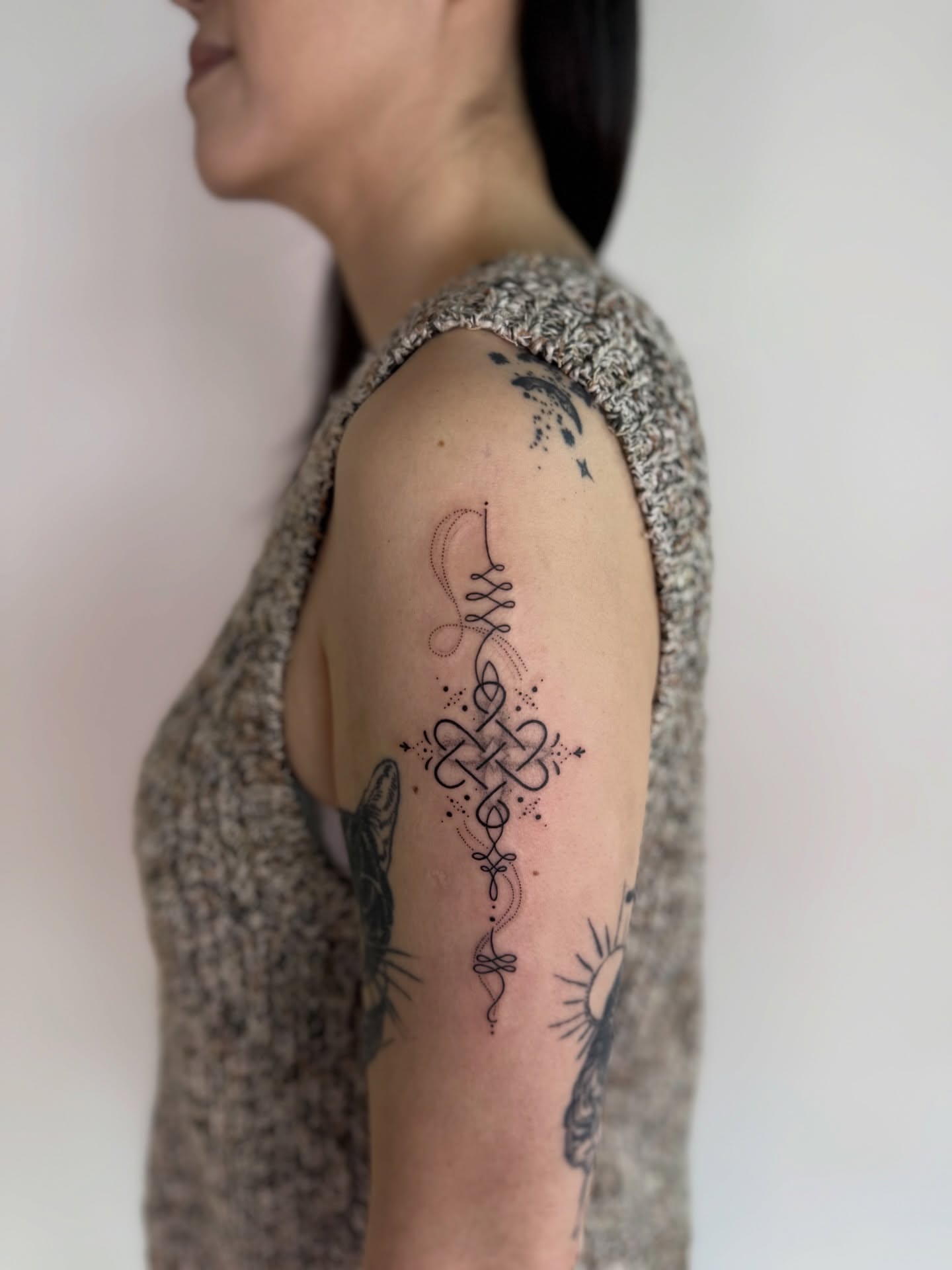 Cross black and grey tattoo on the upper arm by Jena Perry