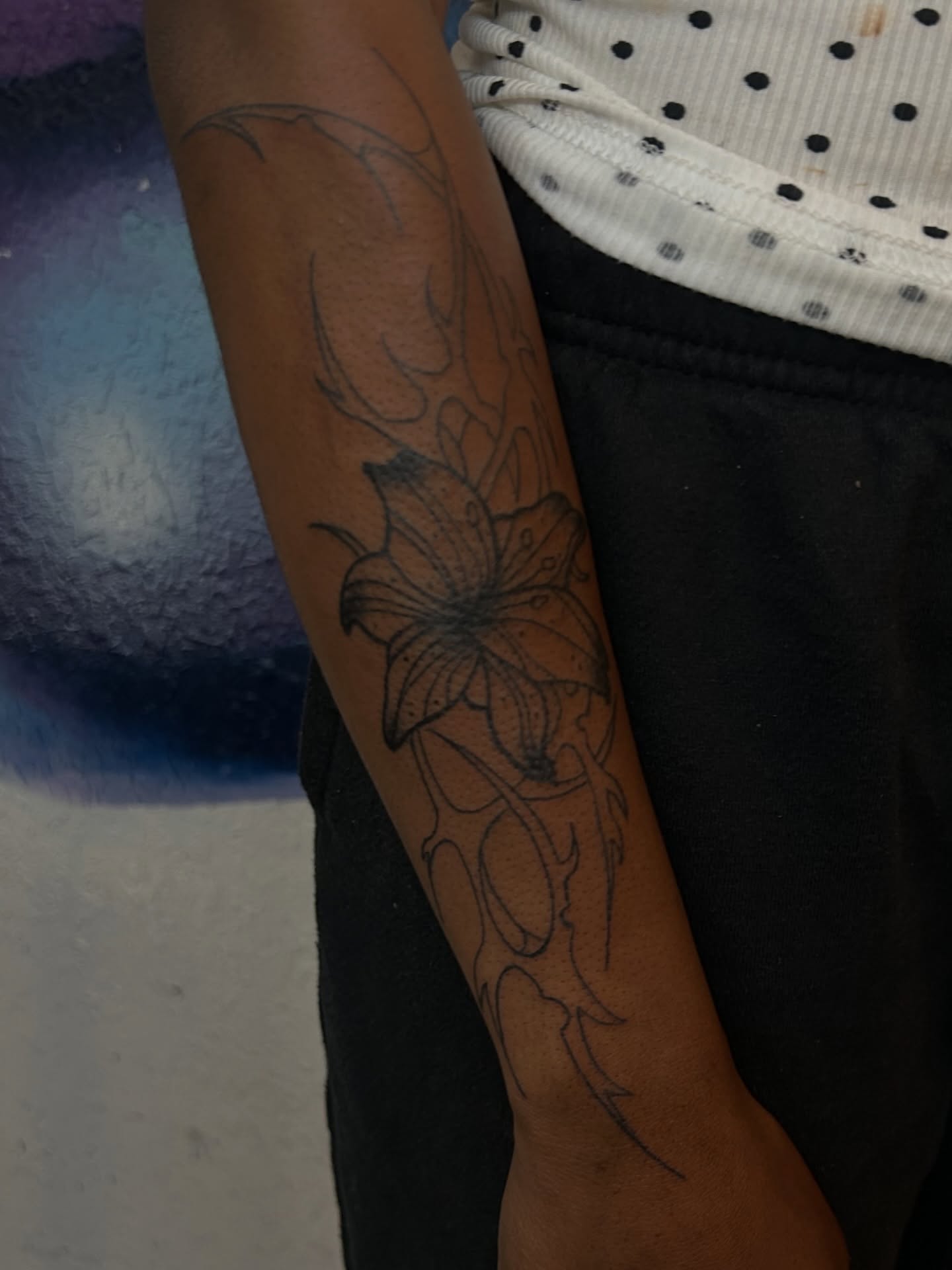 Lily black and grey tattoo on the forearm by Miss Moezartt the Multidisciplinary