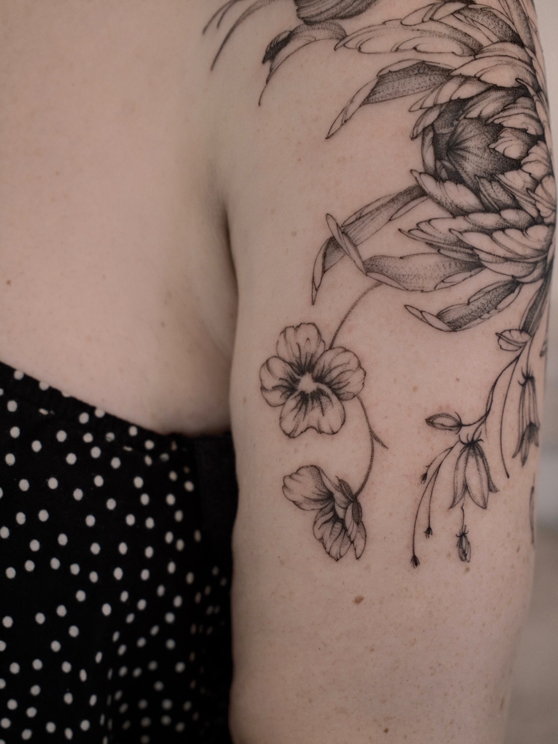Floral arrangement realism tattoo on the upper arm by Joy, Gold Coast, Queensland