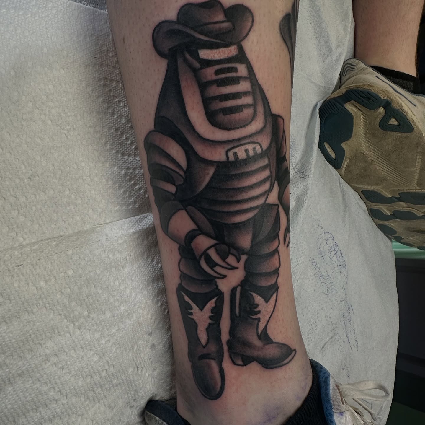 Cowboy robot black and grey tattoo on the forearm by Kyle Simmons