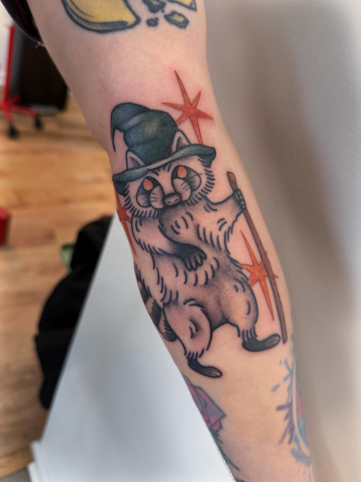Raccoon wizard American traditional tattoo on the forearm by rocky love