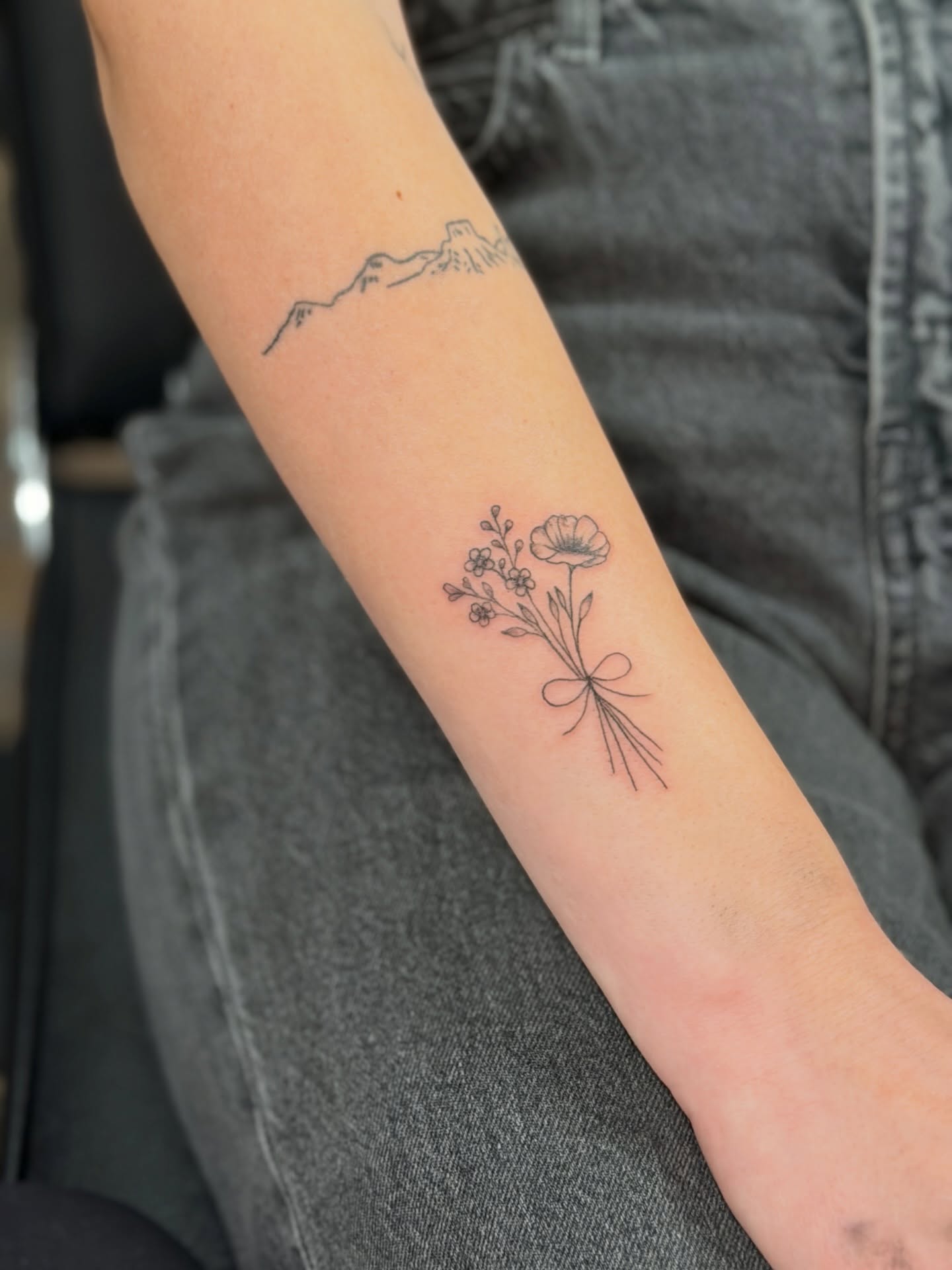 Flower bouquet fine line tattoo on the forearm by JAmy Winters