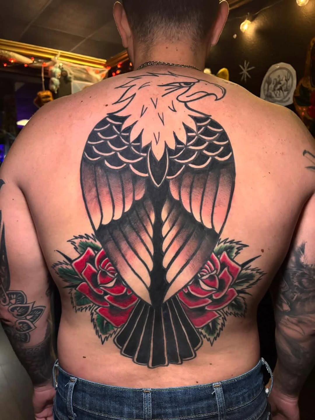 Eagle and roses geometric tattoo on the back by Haley Byers