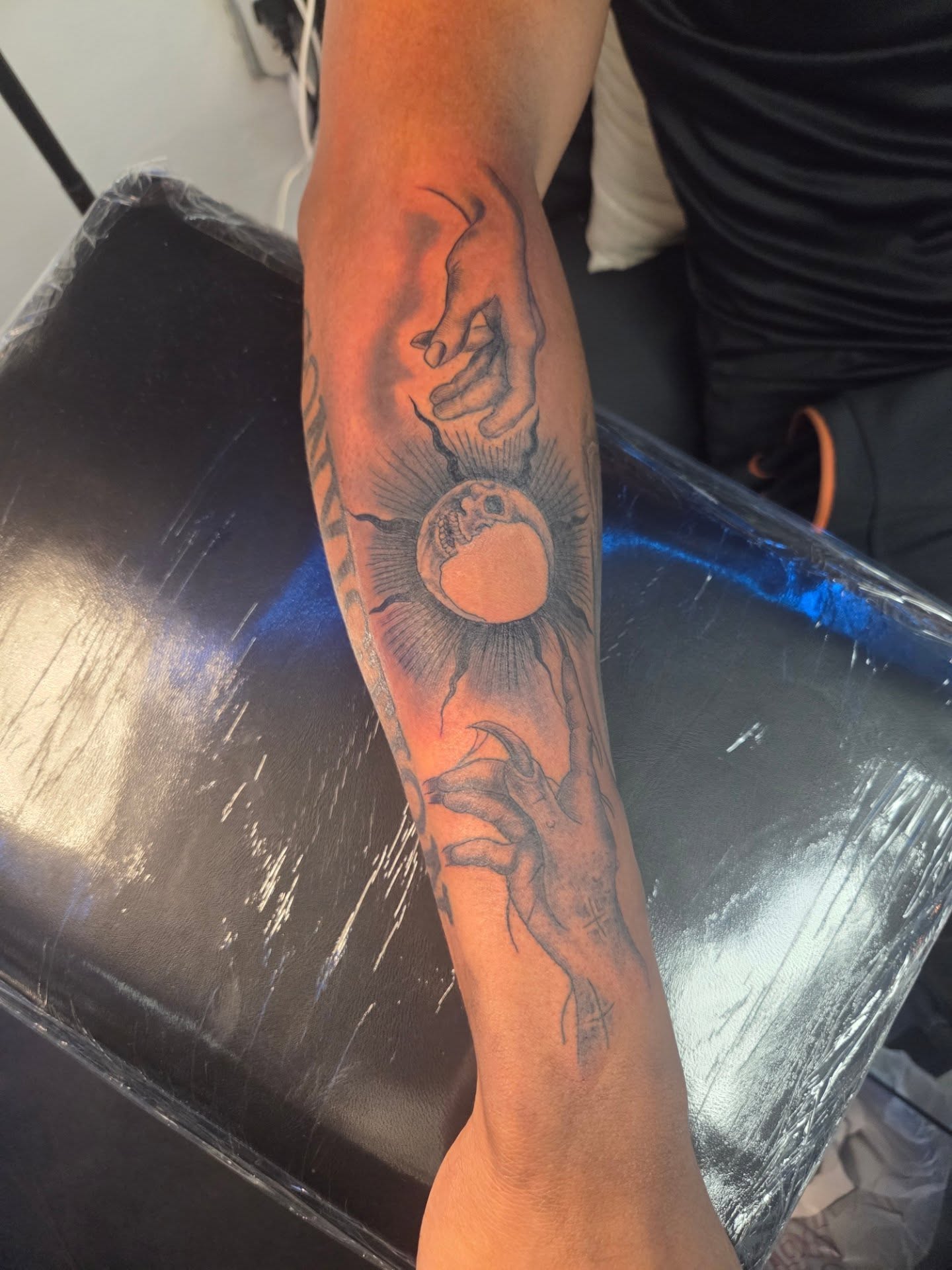 Solar eclipse realism tattoo on the forearm by Klazzik Mayfield, Fort Lauderdale, Florida