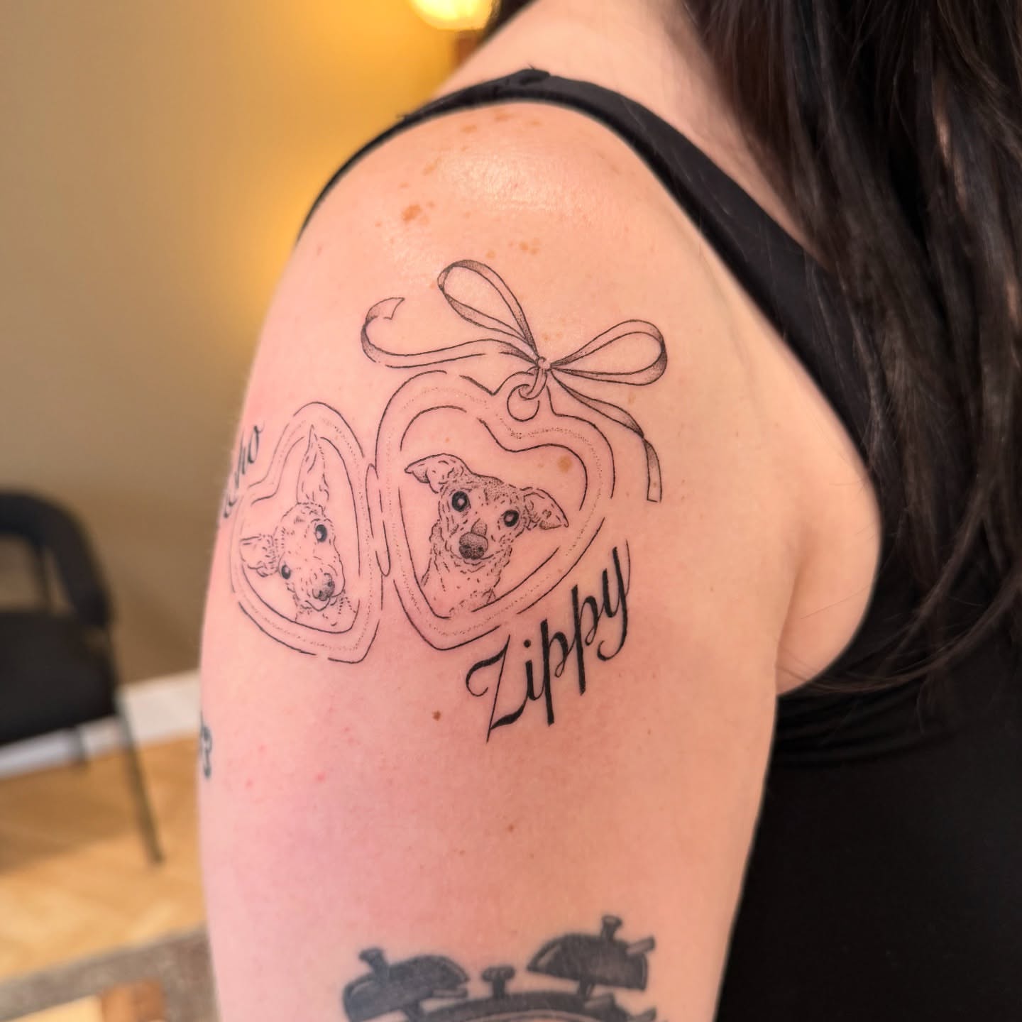 Dog black and grey tattoo on the shoulder by Fine Line Tattoos