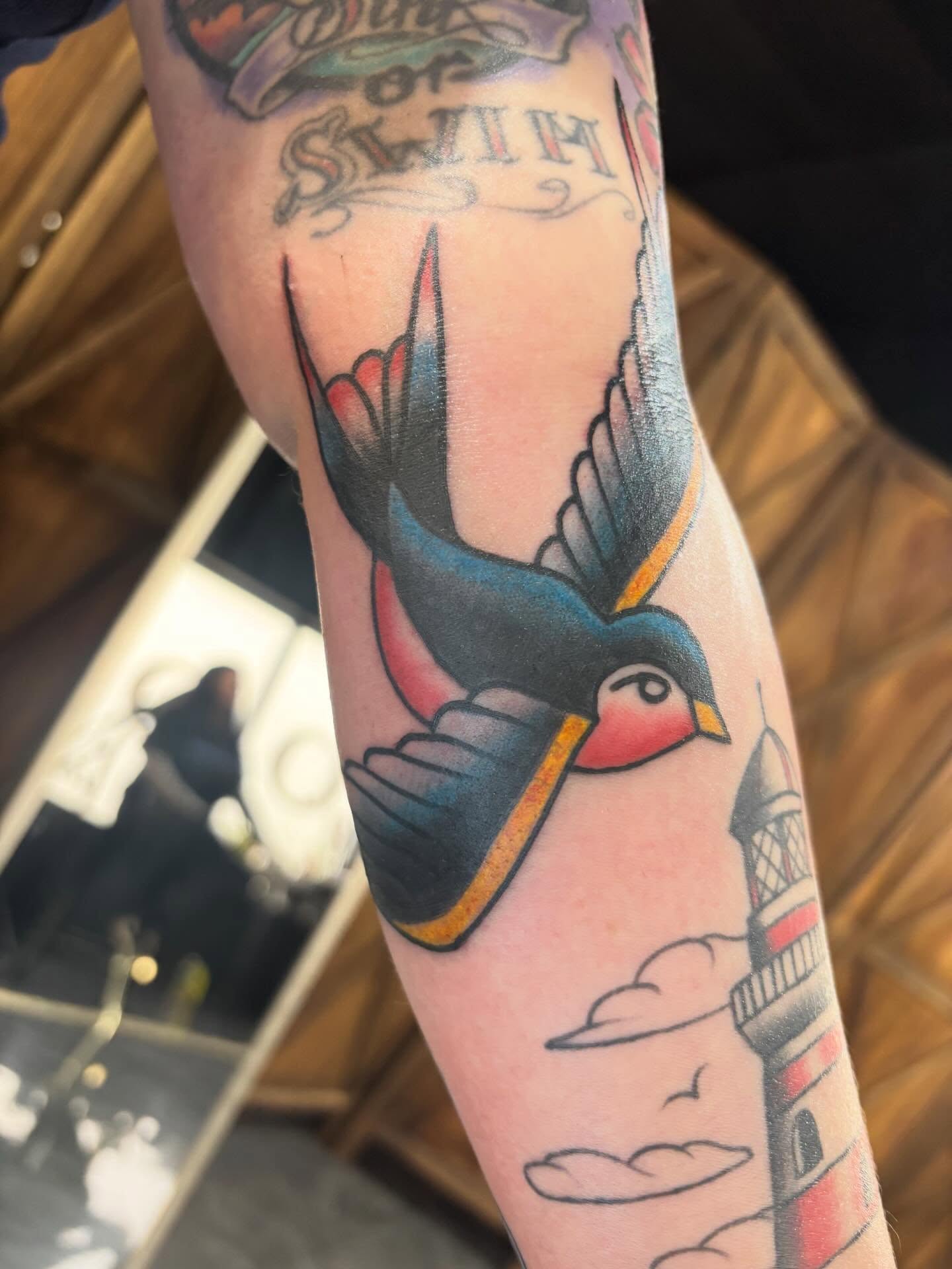 Swallow American traditional tattoo on the forearm by Alex Green, Nashville, Tennessee