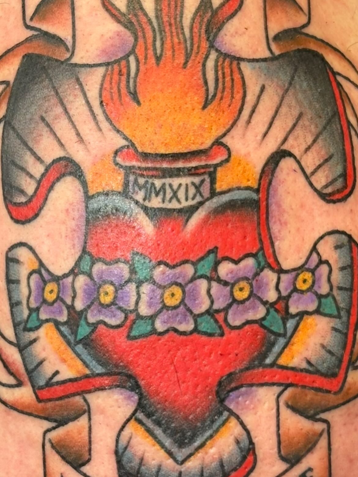 Flame and heart American traditional tattoo on the chest by Scottbarrytattoos@gmail.com