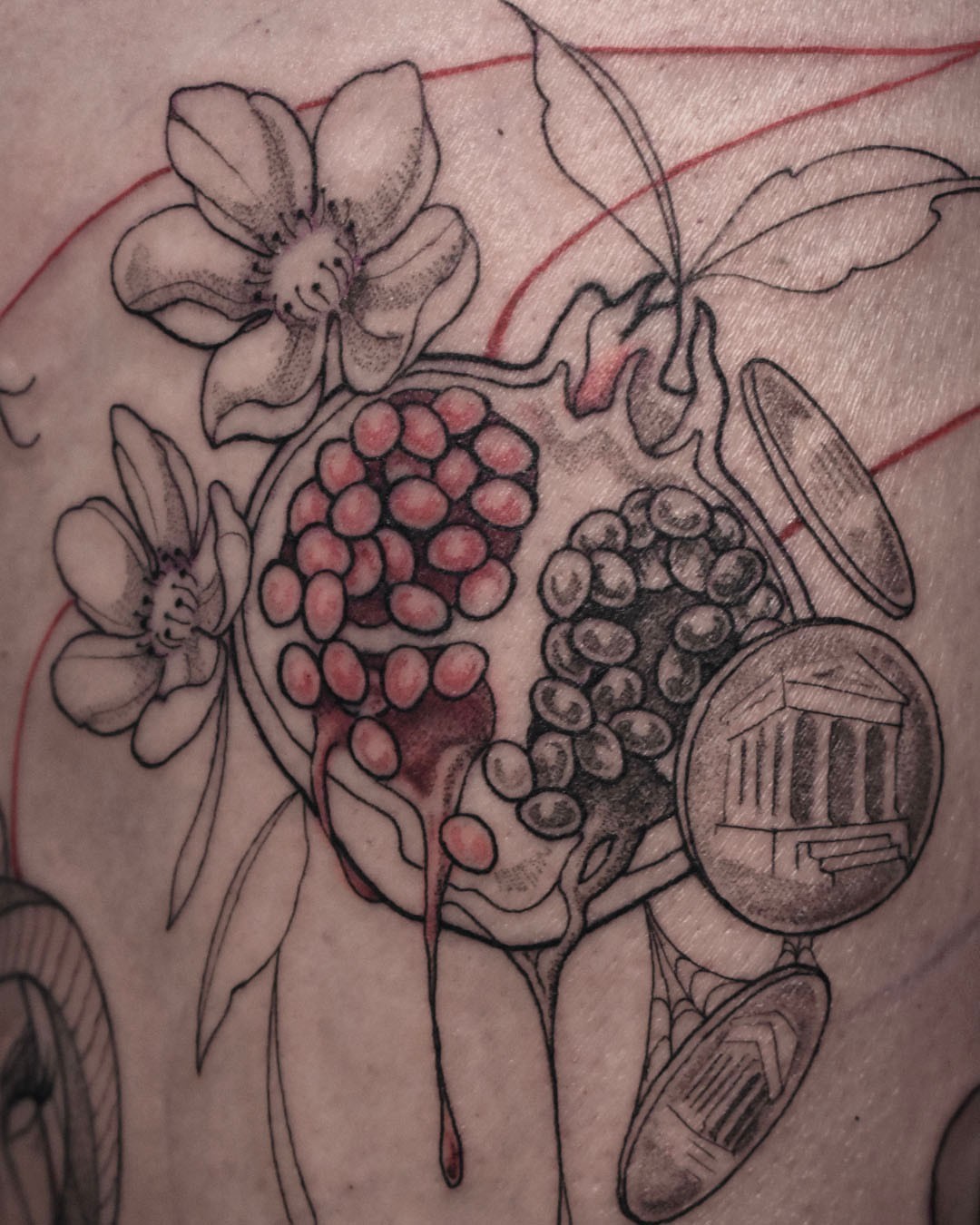 Pomegranate and flowers black and grey tattoo on the forearm by Erin Isaacs