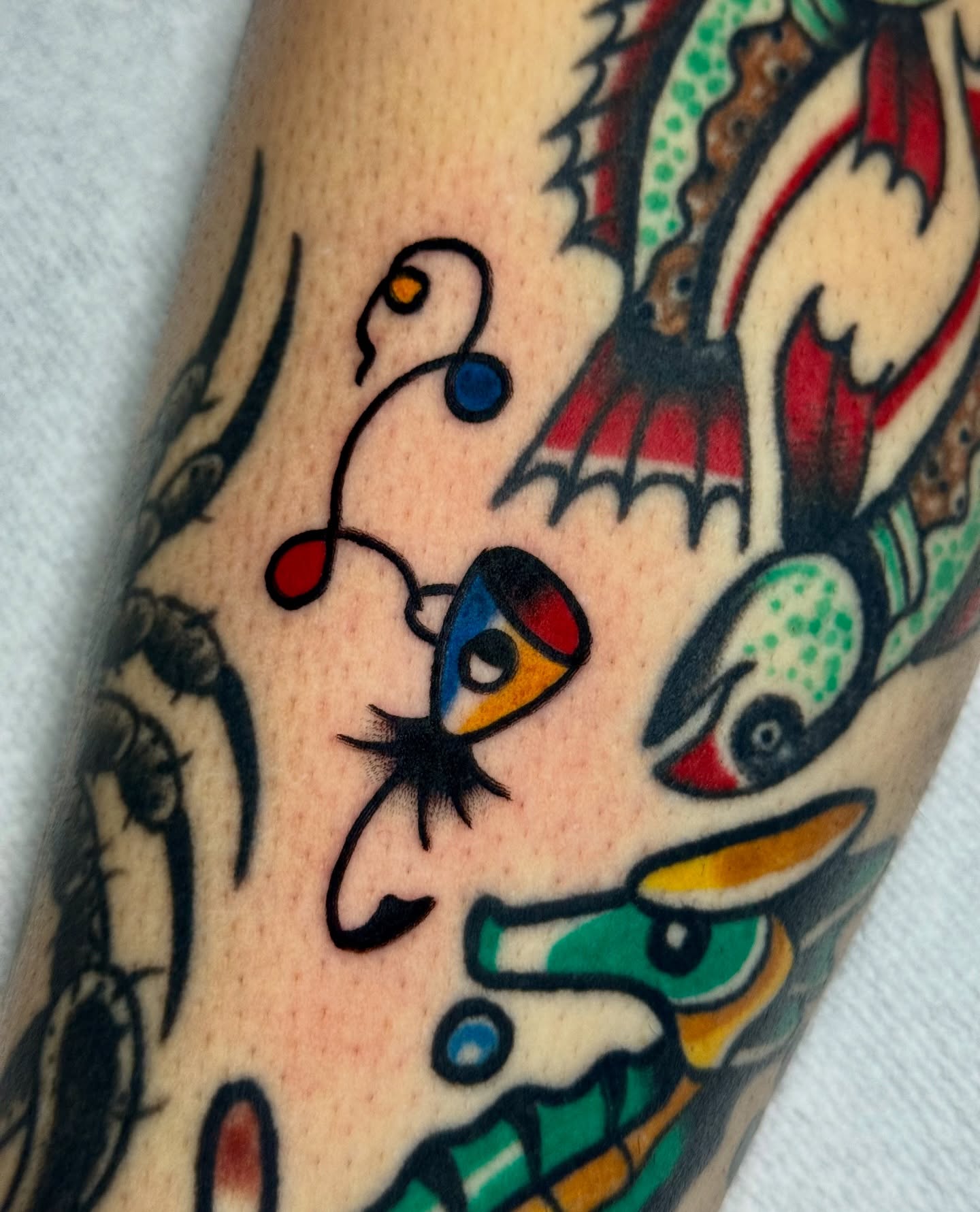 Abstract face American traditional tattoo on the forearm by Javin Klingelhoefer Mosley